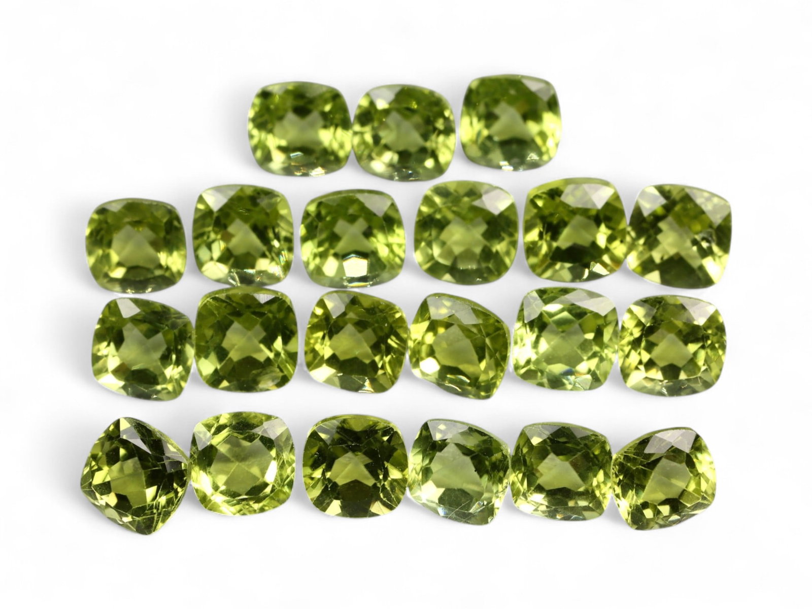 14.88 Carats Golden Green Peridot Cushion Lot - Natural Pakistani Stones: This beautifully matched parcel of cushion-cut peridot glows with a lively golden-green hue, radiating warmth and vibrancy. Each stone is cut with a checkerboard-style crown that enhances brilliance a