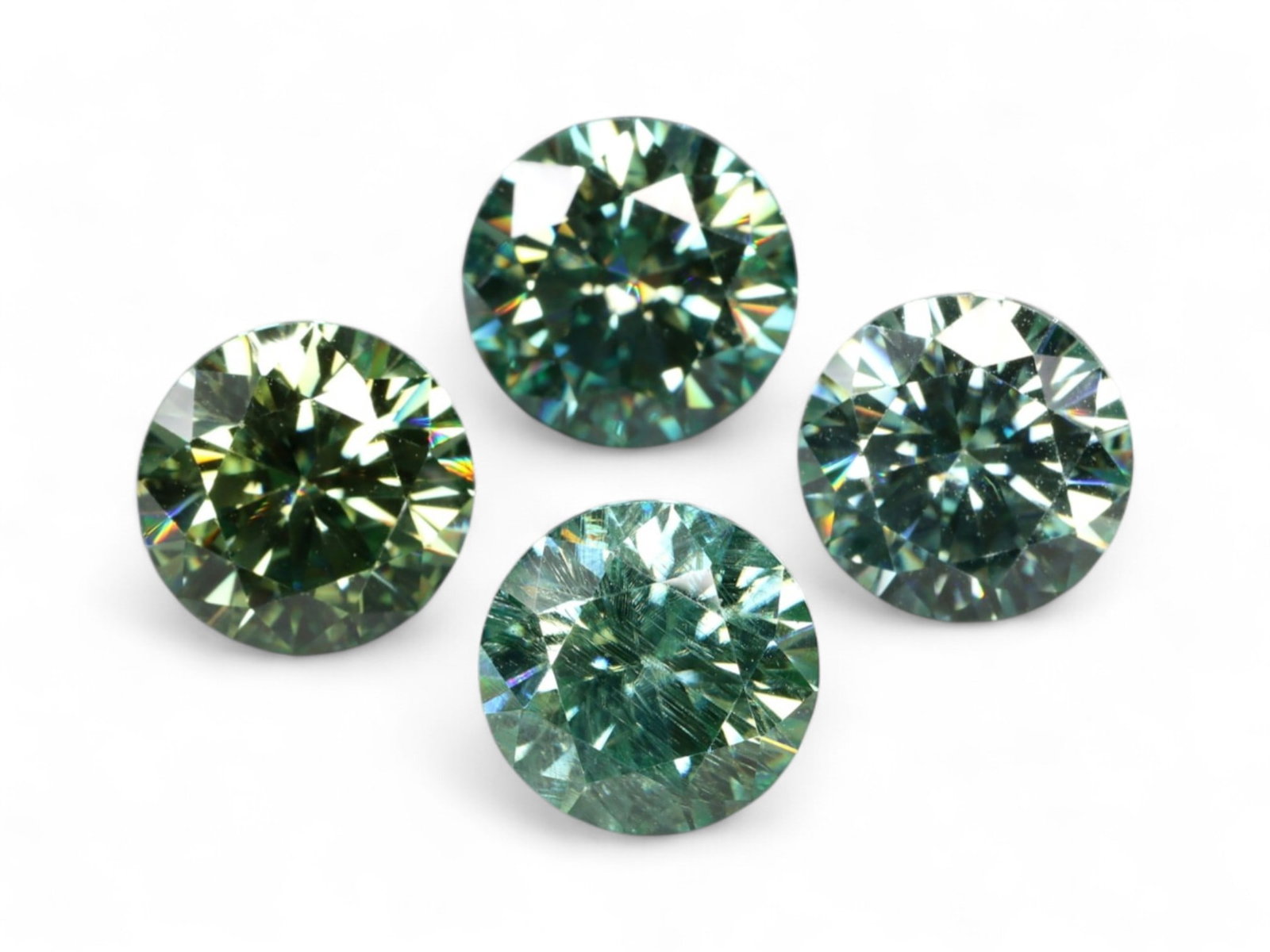 7.09 Carats Green-Teal Moissanite Round Lot - Natural-Look Fancy Color Stones: This captivating quartet of round moissanite gems shimmers with a rare green-teal hue, blending oceanic coolness with diamond-like brilliance. Each stone exhibits vibrant fire and sharp faceting, crea