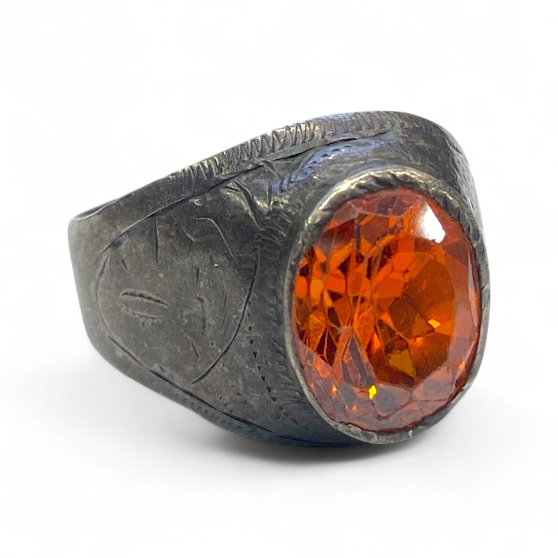 Antique Levantine Engraved Silver Ring with Faceted Orange Gemstone, c. Early 20th Century, 7g: This antique silver ring, likely produced in the early 20th century across the Levant or Ottoman territories, features a striking faceted orange gemstone set into a sturdy engraved bezel. Radiating wa