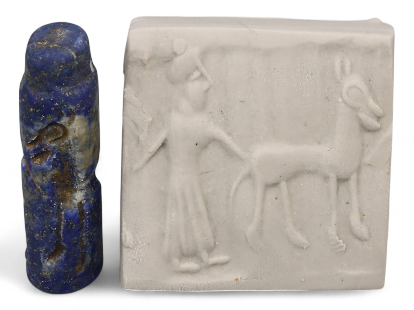 Ancient Akkadian Hero and Goat Motif Lapis Lazuli Cylinder Seal, c. 2350-2150 BCE, 5.4g: This exceptional lapis lazuli cylinder seal, dating to the Akkadian Period (c. 2350-2150 BCE), captures the dynamic interplay of human and animal imagery in Mesopotamian art. Measuring approximately 1
