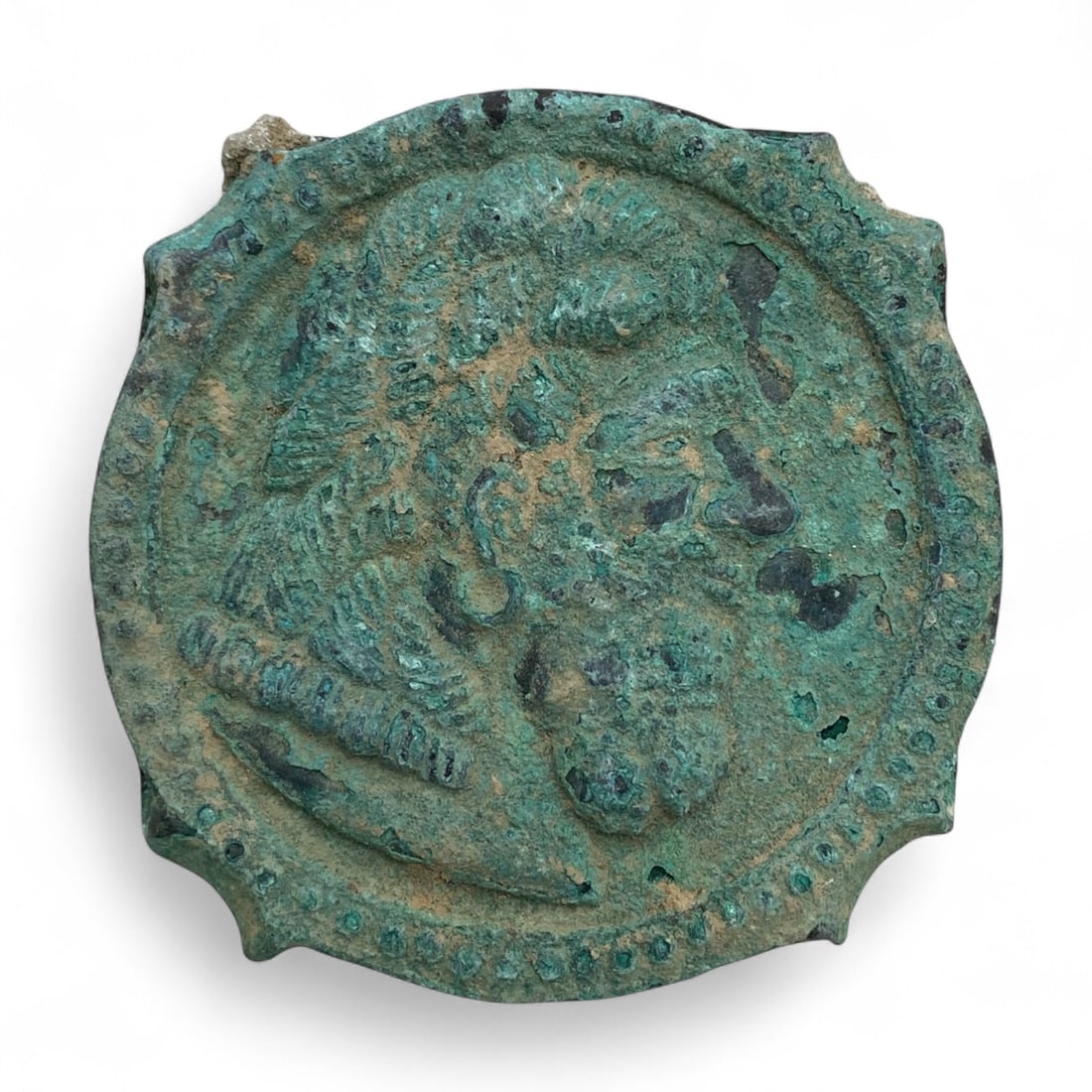 Ancient Byzantine Bronze Belt Buckle with Warrior Motif, c. 10th-12th Century CE, 137g: This robust bronze belt buckle, dating to the 10th-12th century CE, is a fine example of Byzantine martial ornamentation. Circular in form with subtly scalloped edges, the buckle face features a relie