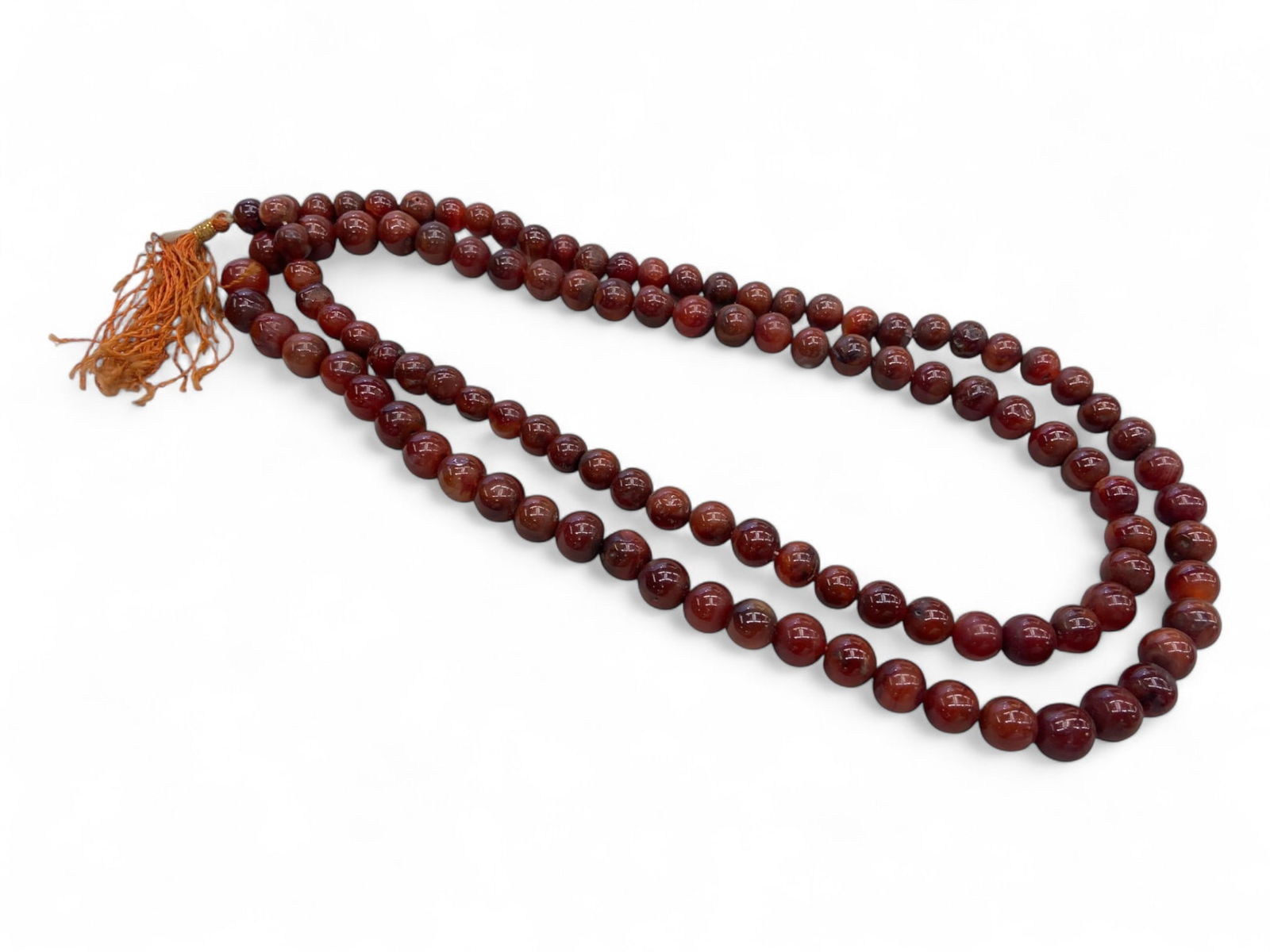 Tibetan Carnelian Prayer Mala of 108 Beads with Guru Bead, c. 19th-20th Century, 133g: This radiant Tibetan prayer mala, composed of 108 carnelian beads plus a central guru bead, embodies a long-standing tradition of meditative devotion and spiritual repetition. Weighing 4.69 ounces (13