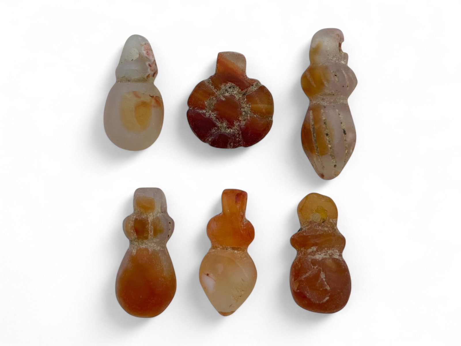 Ancient Coptic Egyptian Fertility & Solar Symbol Carnelian Amulets, 6pcs, c. 4th-7th Century CE, 8g: These six vibrant amulets, crafted from richly toned carnelian, reflect the deeply rooted Coptic Egyptian traditions of spiritual protection, fertility symbolism, and solar reverence during the transi