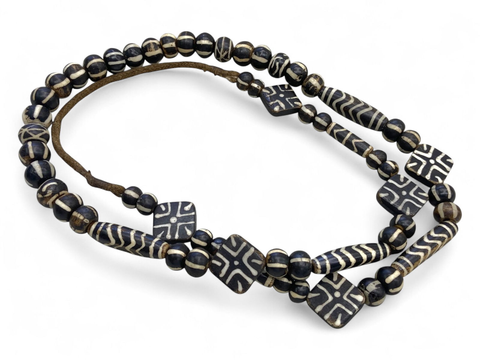 Antique Himalayan Pumtek Wood Beads Strand with Geometric Inlays, c. 18th-19th Century CE, 126g: This striking strand of antique Pumtek beads, weighing 126 grams, exemplifies the deep spiritual and cultural heritage of the Chin and other highland communities of the Eastern Himalayas. Carved from