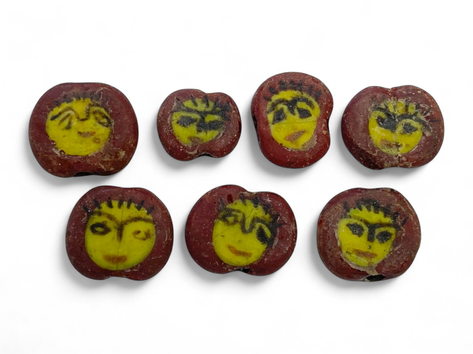 Ancient Egyptian Mosaic Glass Face Beads Set of 8, c. 1st Millennium BCE, 8g: These captivating ancient Egyptian face beads, dating from the 1st millennium BCE, are extraordinary examples of mosaic glass craftsmanship from a civilization renowned for its symbolic artistry. Each