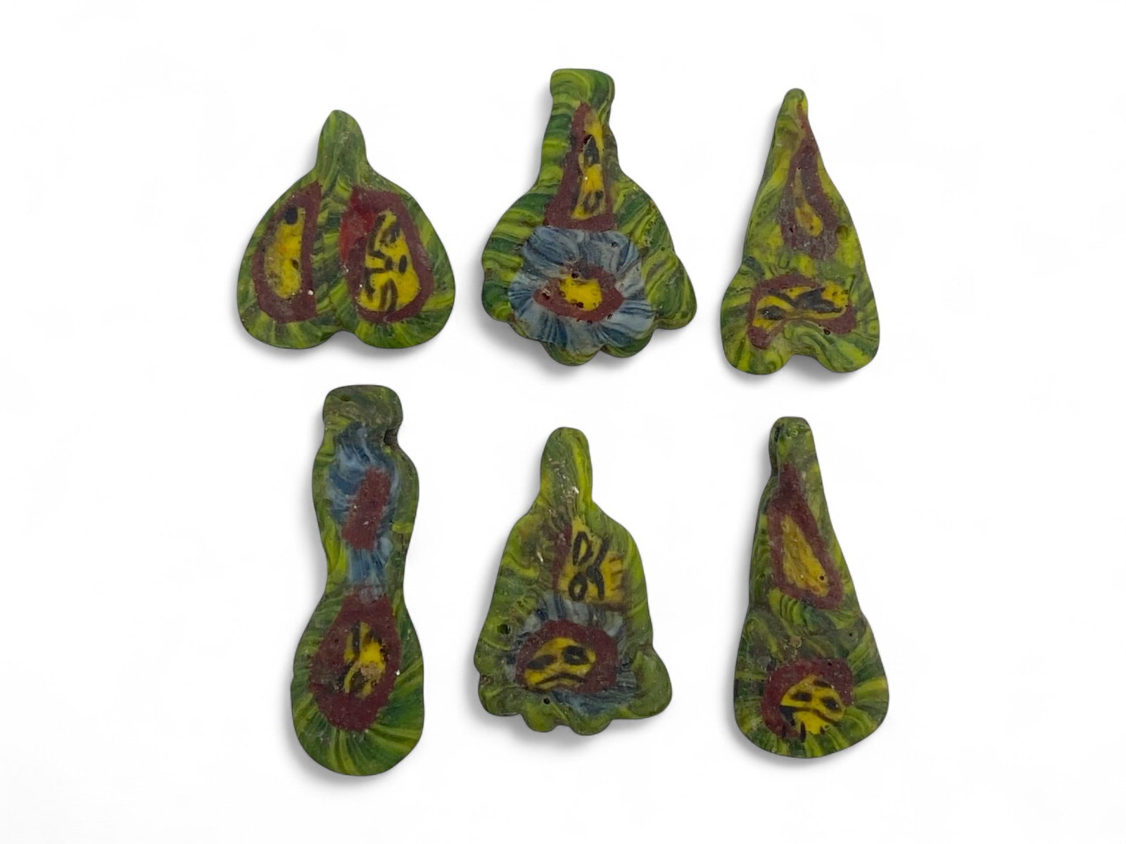 Ancient Egyptian Millefiori Face Beads Set of Floral and Abstract Forms, 1st Millennium BCE, 10g: This extraordinary set of six ancient Egyptian face beads, dating from the 1st millennium BCE, is a vivid example of the culture's fascination with color, divine imagery, and personal protection. Craf