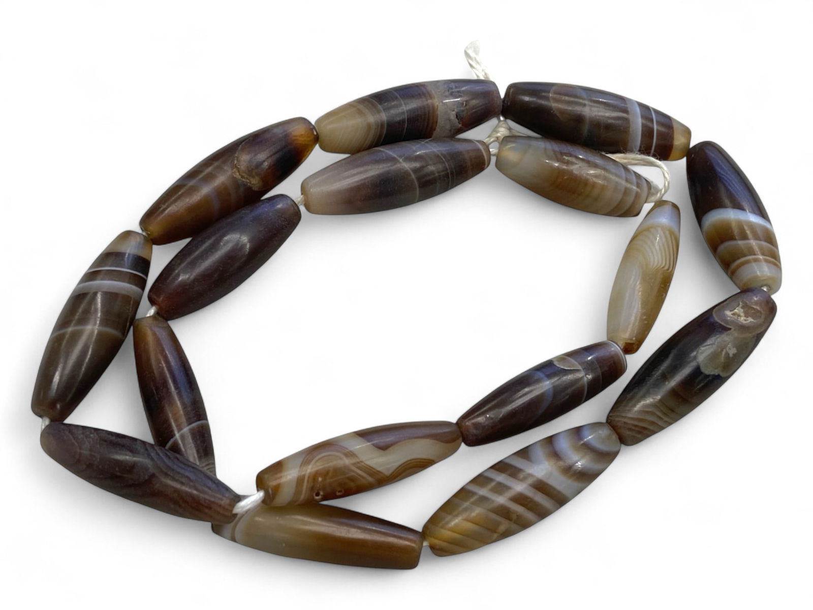 Antique Indo-Tibetan Banded Agate Barrel Beads Strand, c. 18th-19th Century, 59g: This refined strand of antique agate beads, likely originating from the Indo-Tibetan region in the 18th to 19th century, captures the natural elegance and spiritual resonance of banded agate. The ston
