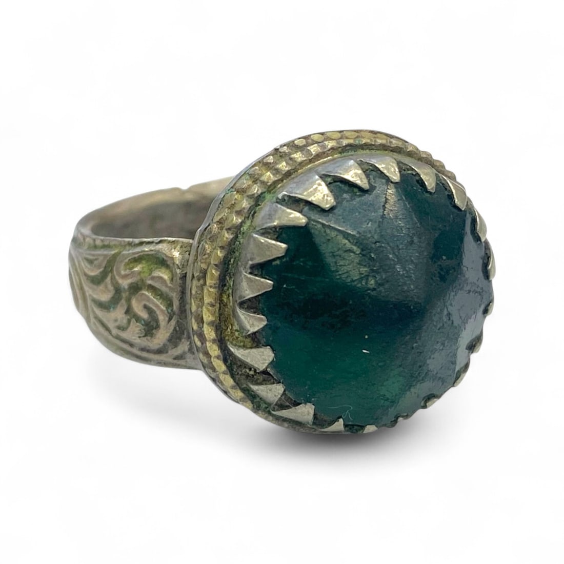 Antique Ottoman Tribal Green Gem Silver Ring with Saw-Tooth Bezel, c. 19th Century, 10g: This bold antique silver ring from the 19th century blends tribal craftsmanship with Ottoman-era influences, centered around a dark green faceted gem encased in a dramatic saw-tooth bezel. The ring's 