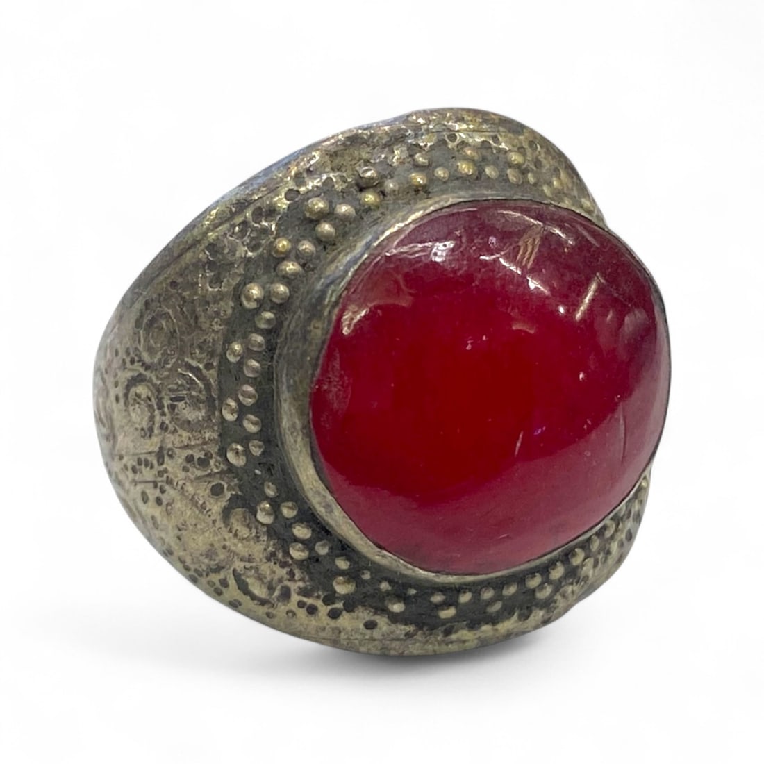 Antique Central Asian Granulated Silver Ring, Red Domed Glass Cabochon, c. 19th Century, 12g: This substantial antique silver ring from Central Asia, dating to the 19th century, commands presence with its bold red glass cabochon and masterful granulated detailing. Likely originating from regio