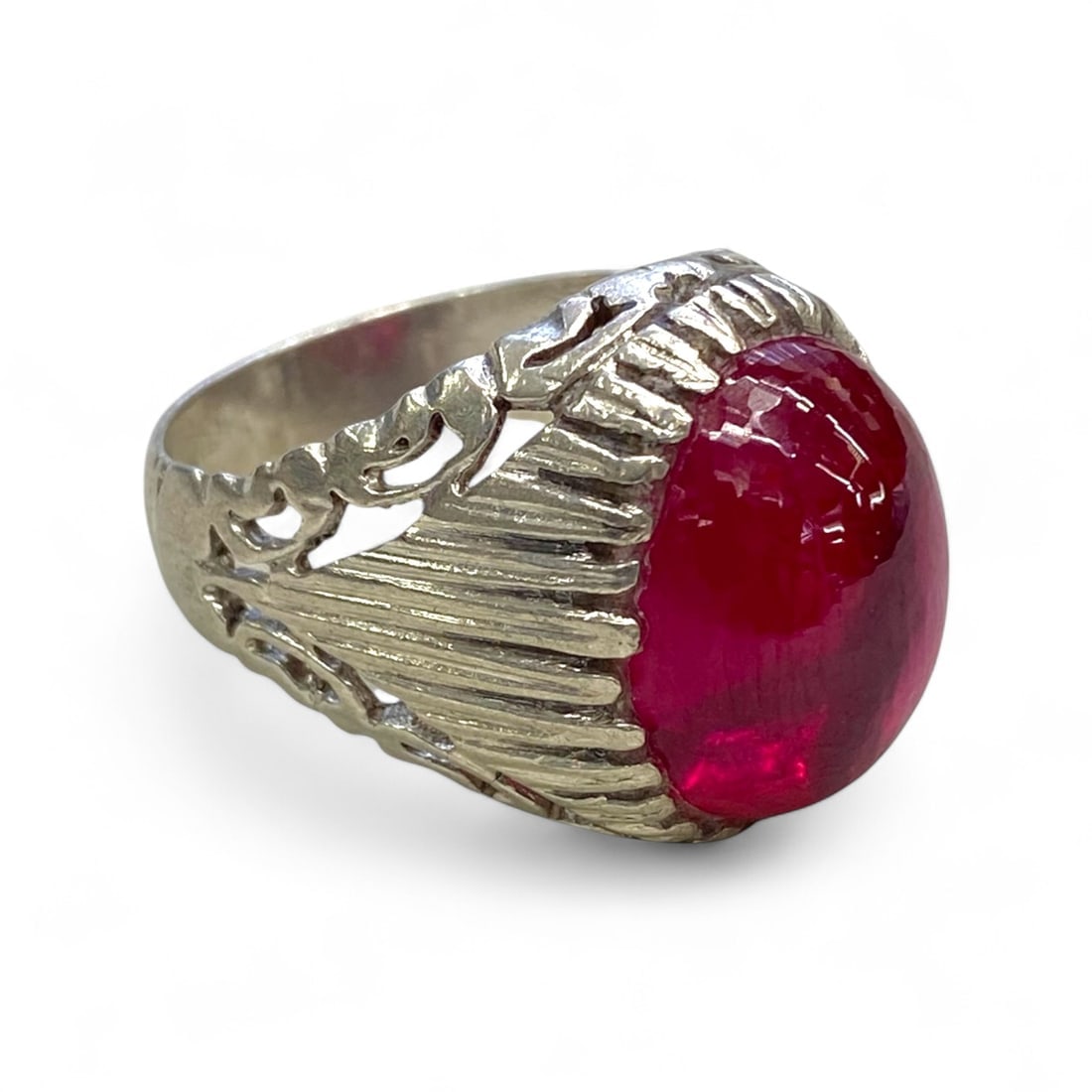 Antique European Silver Filigree Ring with Red Glass Cabochon, c. Mid-20th Century, 11g: This eye-catching antique European ring features a vibrant red glass cabochon cut en cabochon, set in an ornate silver filigree mount. The setting's design combines radiating ridges and openwork scrol