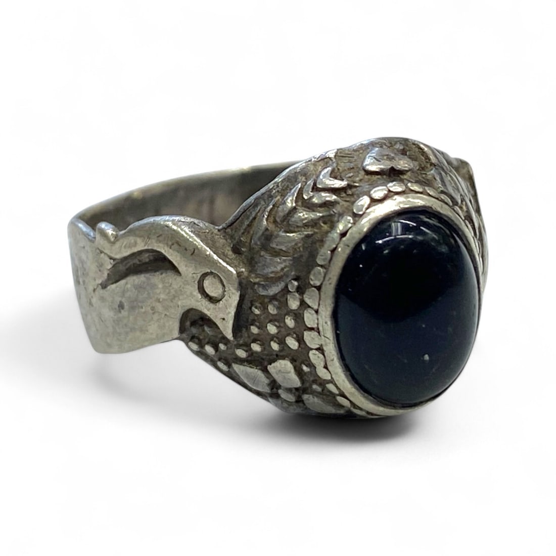 Antique Central Asian Eagle-Head Silver Ring with Dark Cabochon Stone, c. Early 20th Century, 5g: Rooted in the bold artistic traditions of Central Asia, this antique silver ring showcases a dynamic blend of animal symbolism and warrior-style ornamentation. Likely dating to the early 20th century,