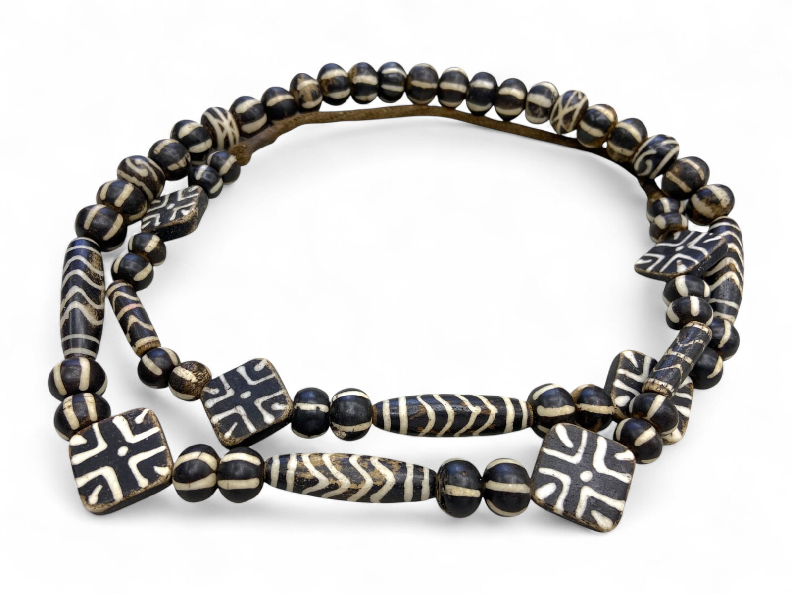 Antique Himalayan Pumtek Wood Beads Strand with Geometric Inlays, c. 18th-19th Century CE, 132g: This striking strand of antique Pumtek beads, weighing 126 grams, exemplifies the deep spiritual and cultural heritage of the Chin and other highland communities of the Eastern Himalayas. Carved from