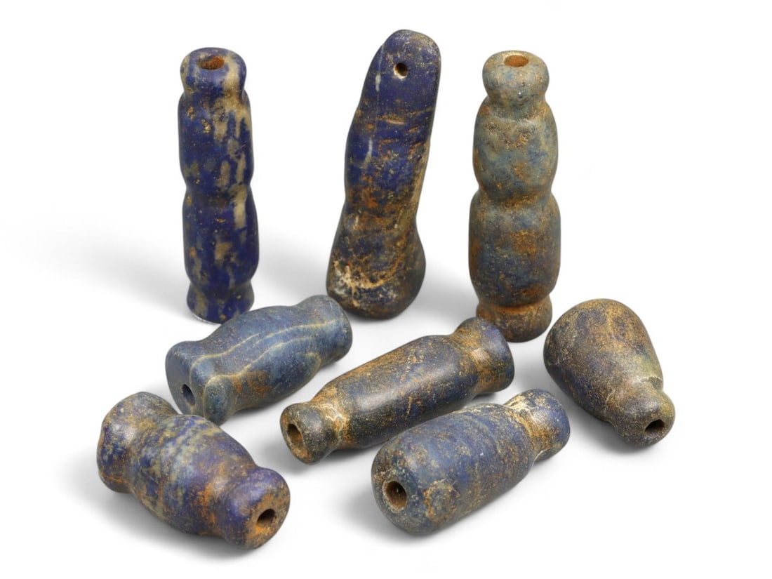 Ancient Bactrian Lapis Lazuli Spindle-Shaped Beads Set, c. 3rd-2nd Millennium BCE, 41.6g: This striking collection of ancient Bactrian beads, dating to the 3rd-2nd millennium BCE, showcases an array of spindle and bi-conical forms meticulously carved from deep blue lapis lazuli. These eleg