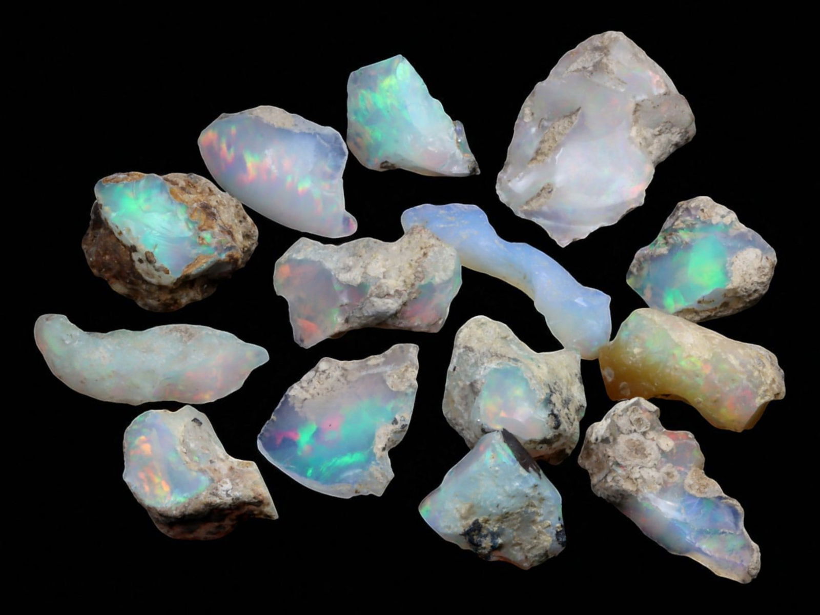 11.00 Grams Multicolor Welo Opal Rough Selection - Natural Ethiopian Stones: This dynamic selection of Welo opal rough radiates with the unmistakable fire that has made Ethiopian opal a favorite among collectors and artisans. Each piece flashes with vibrant play-of-color, from