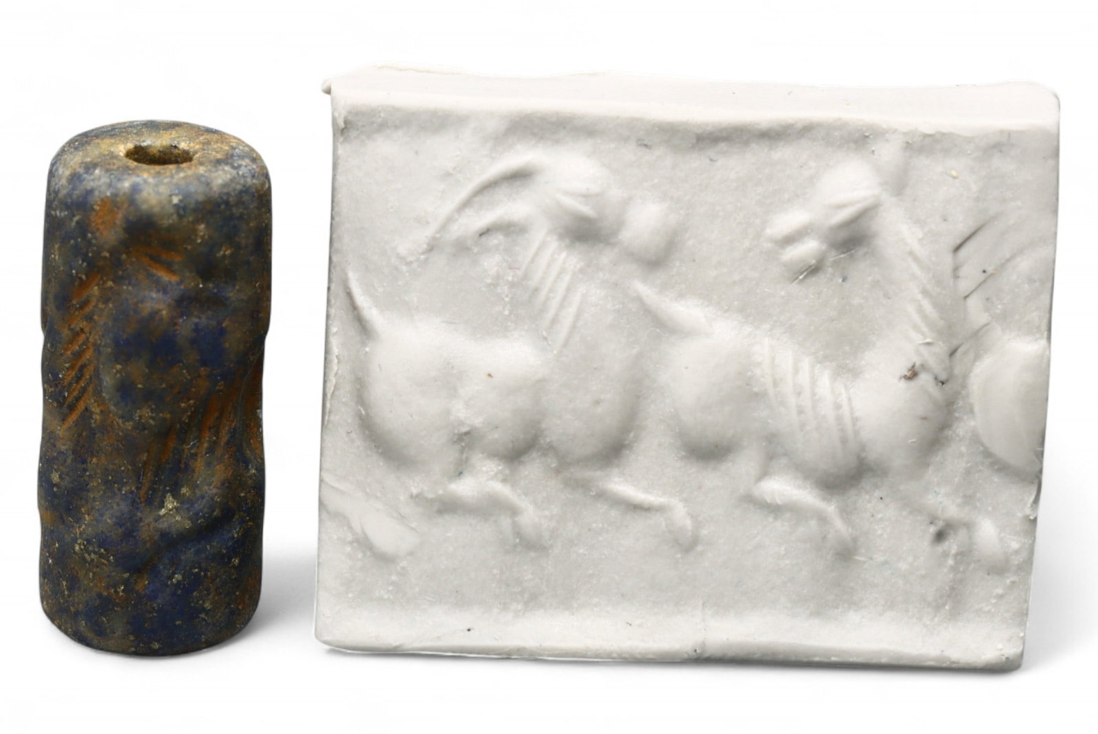 Ancient Akkadian Mythical Creature High-Relief Lapis Lazuli Cylinder Seal, c. 2350-2150 BCE, 6.2g: This rare Akkadian cylinder seal, intricately carved from rich lapis lazuli, offers a mesmerizing glimpse into Mesopotamian mythology and high craftsmanship during the apex of the Akkadian Empire, c. 