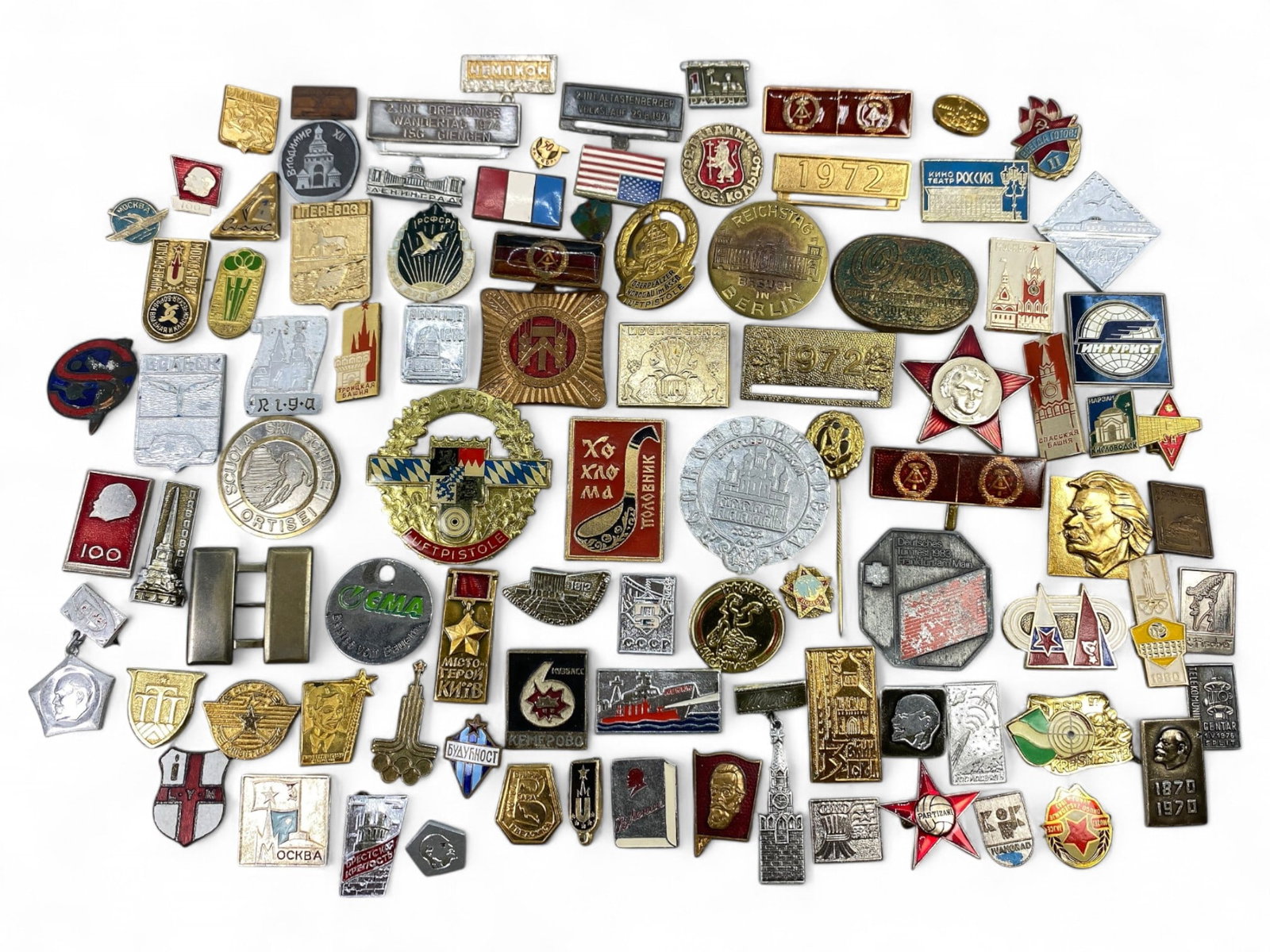 USSR/INTERNATIONAL: Socialist Identity and Cold War Iconography Badge Lot, 253g: This expansive lot of over 90 badges spans the ideological, cultural, and commemorative spectrum of Soviet-era and allied imagery. From Lenin profiles and space-race tributes to city emblems, factory 