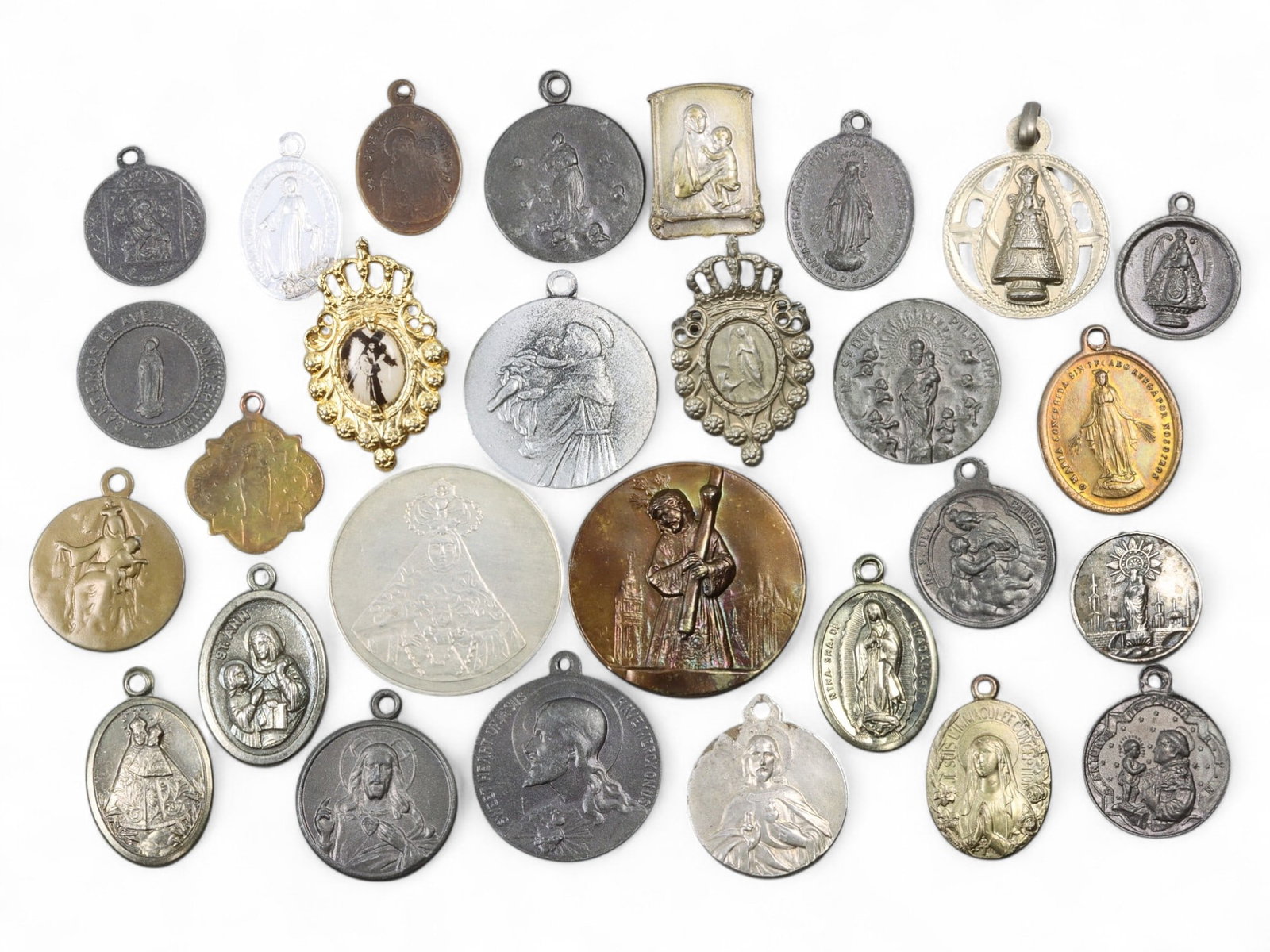 EUROPE/LATIN AMERICA: Marian Devotion - Catholic Religious Medal Lot, 28pcs, 56g: This spiritually resonant lot of 28 devotional medals spans sacred sites and iconographies from Lourdes and Montserrat to Our Lady of Guadalupe and Our Lady of Olives. Struck in various metals and for