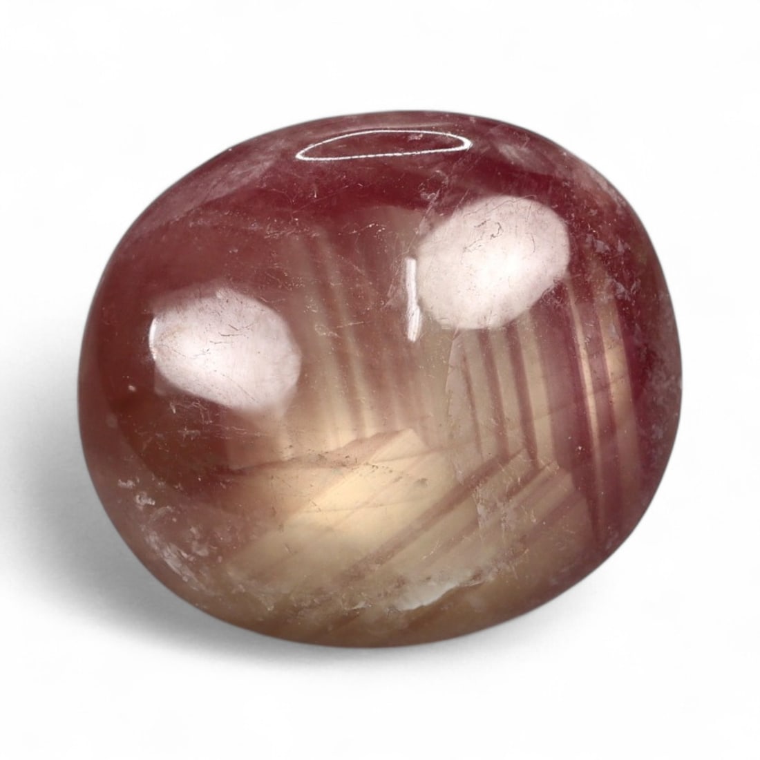 16.08 Carats Bi-Color Pink Sapphire Cabochon - Natural Corundum from Madagascar: This rare bi-color sapphire cabochon presents a graceful interplay of blush pink and warm champagne tones, layered with internal zoning that adds depth and character. The smooth, domed surface reveals