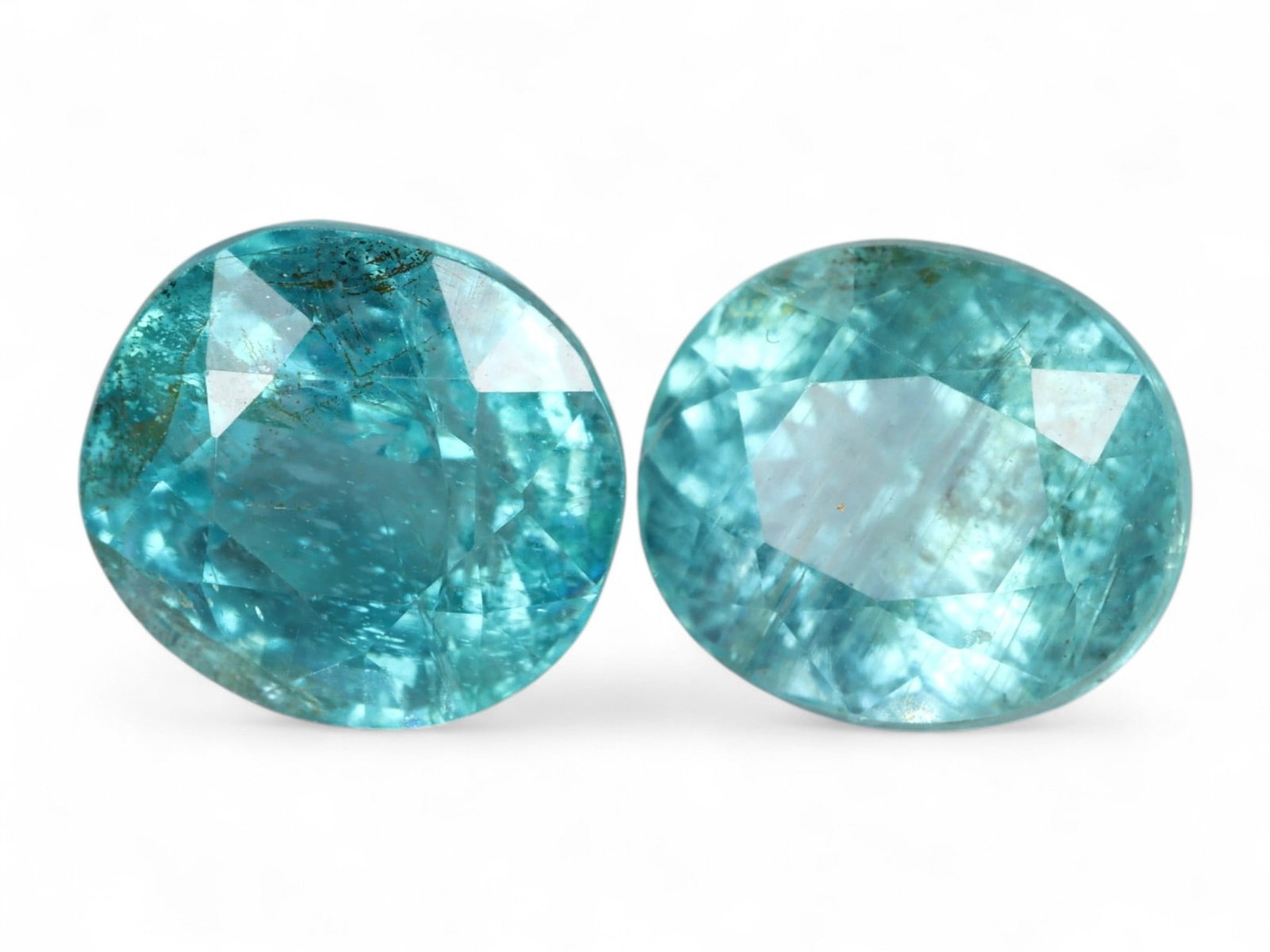 2.86 Carats Paraiba Blue Apatite Pair - Natural Oval Cut Gems: This glowing pair of oval-cut apatite gems radiates with the electric allure of Paraiba blue-an intense turquoise hue with luminous clarity and vibrant sparkle. Each stone displays a slightly differen