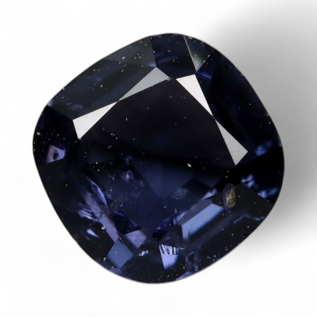 1.00 Carat Deep Indigo Spinel Cushion - Natural Burmese Stone: This one-carat Burmese spinel boasts a rich indigo hue, sitting gracefully between violet and midnight blue. The cushion cut enhances its moody depth while allowing light to flicker through the darker