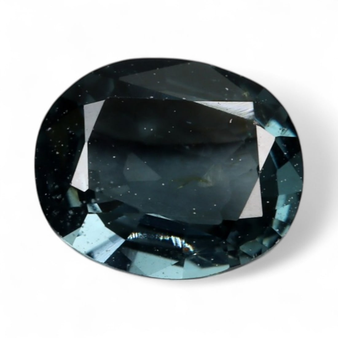 0.76 Carats Teal-Black Spinel Oval - Natural Burmese Stone: This compact Burmese spinel displays a brooding teal-black hue, with flashes of steel blue and charcoal emerging under light. Its oval cut is crisp and well-balanced, enhancing its visual structure wh