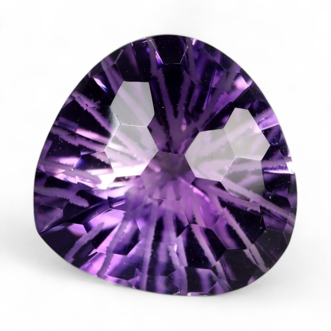 12.30 Carats Starburst Cut Amethyst Trillion - Natural Brazilian Stone: This exceptional trillion-cut amethyst showcases a dramatic starburst pattern, radiating precision and brilliance from its richly saturated violet core. The deep symmetry and crisp faceting amplify in