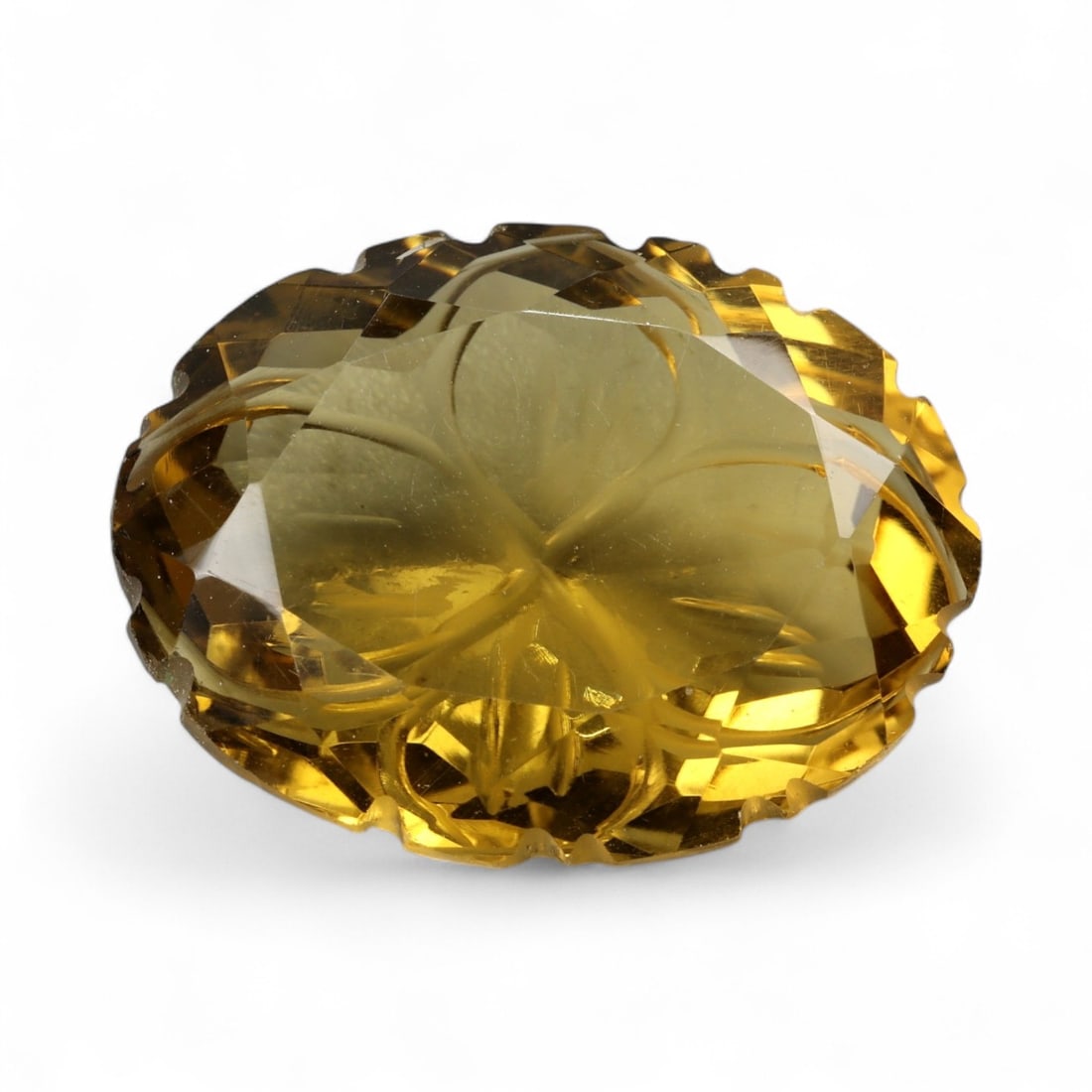 24.70 Carats Golden Champagne Citrine - Natural Brazilian Stone: This commanding citrine is a masterwork of light and form, displaying a warm golden-champagne hue with exceptional internal clarity. Intricately sculpted with radiating lines and layered facet work, t