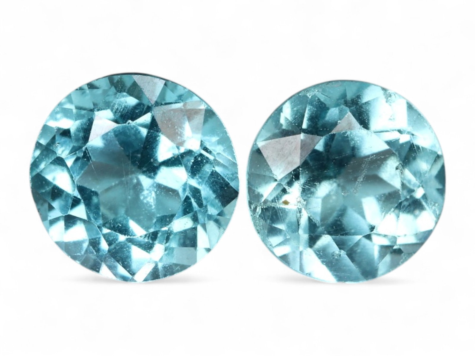 1.22 Carats Paraiba Blue Apatite Pair - Natural Round Cut Gems: This vivid round-cut apatite pair shimmers with an electric Paraiba-inspired blue, capturing the essence of tropical waters in compact, symmetrical form. Each gem features excellent brilliance with fl