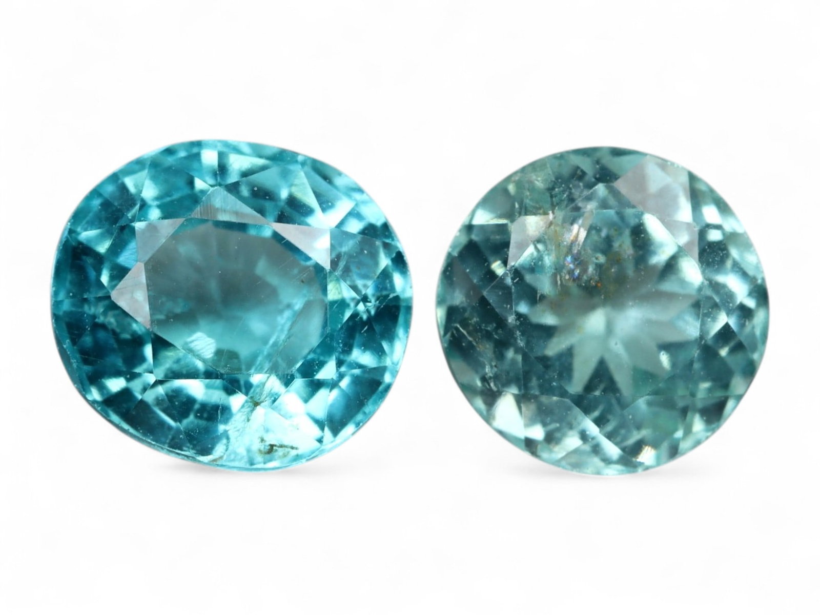 1.84 Carats Paraiba Blue Apatite Pair - Natural Oval Cut Gems: This glowing pair of oval-cut apatite gems radiates with the electric allure of Paraiba blue-an intense turquoise hue with luminous clarity and vibrant sparkle. Each stone displays a slightly differen