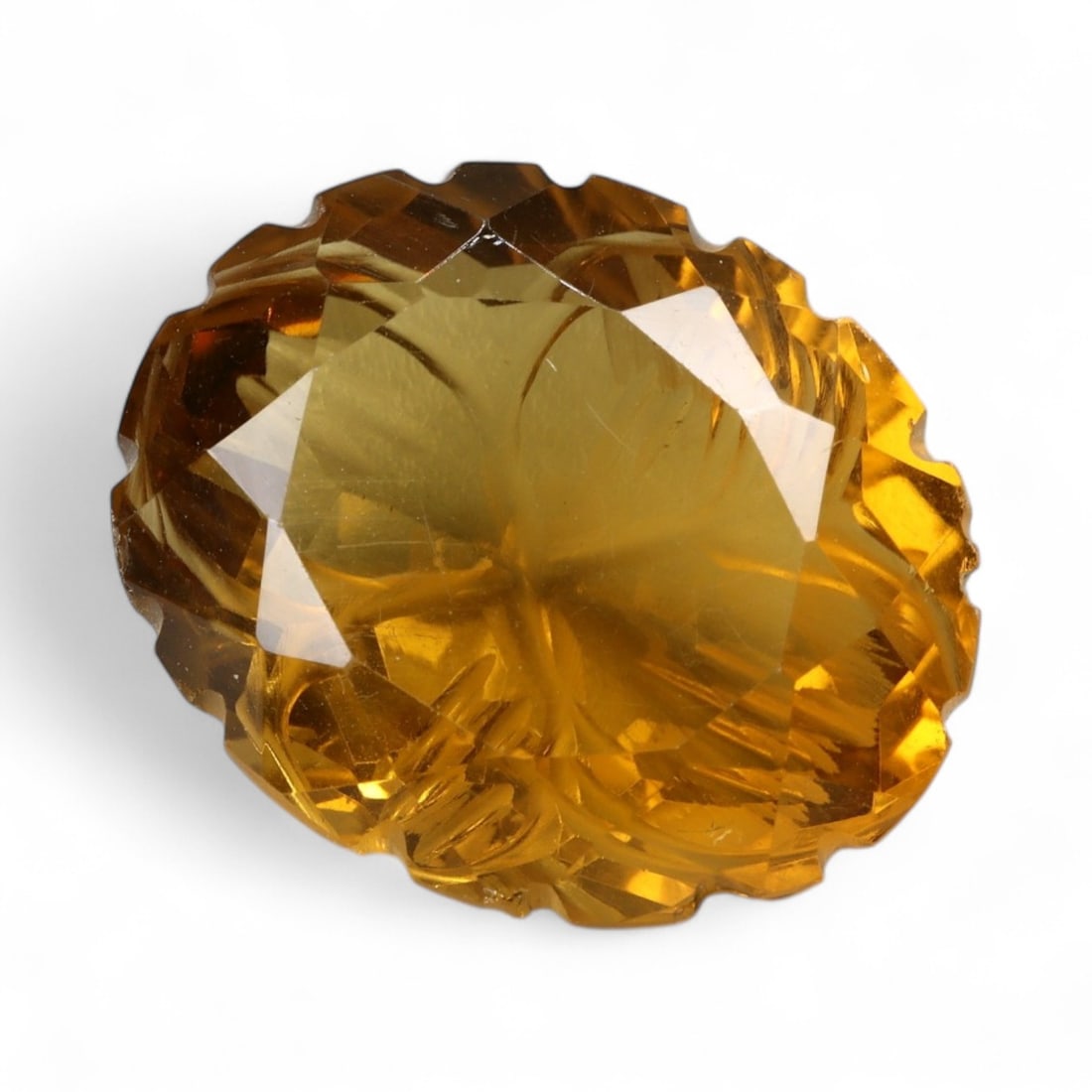 25.75 Carats Golden Champagne Citrine - Natural Brazilian Stone: This commanding citrine is a masterwork of light and form, displaying a warm golden-champagne hue with exceptional internal clarity. Intricately sculpted with radiating lines and layered facet work, t