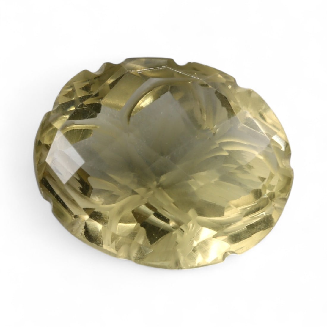 21.60 Carats Golden Champagne Citrine - Natural Brazilian Stone: This commanding citrine is a masterwork of light and form, displaying a warm golden-champagne hue with exceptional internal clarity. Intricately sculpted with radiating lines and layered facet work, t