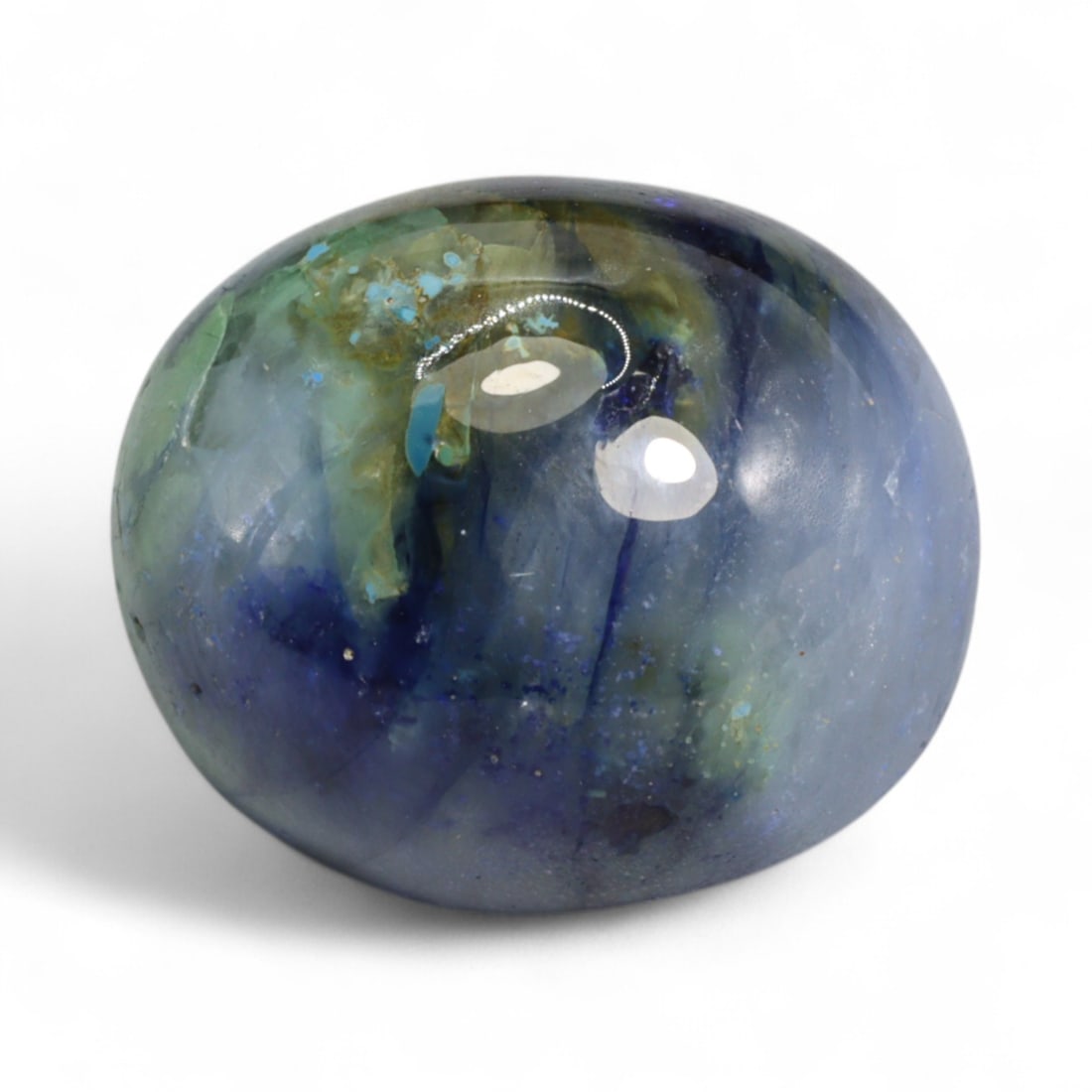 31.29 Carats Royal Blue Sapphire Cabochon - Natural Ceylon Origin: This commanding sapphire cabochon showcases a bold royal blue hue with swirling silvery inclusions that shimmer beneath the surface, giving it both color intensity and visual intrigue. Its polished do