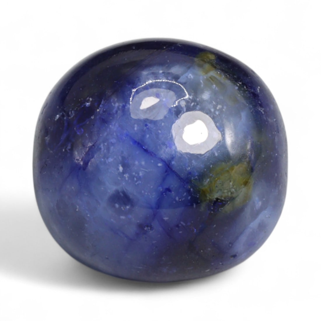 25.57 Carats Royal Blue Sapphire Cabochon - Natural Ceylon Origin: This commanding sapphire cabochon showcases a bold royal blue hue with swirling silvery inclusions that shimmer beneath the surface, giving it both color intensity and visual intrigue. Its polished do