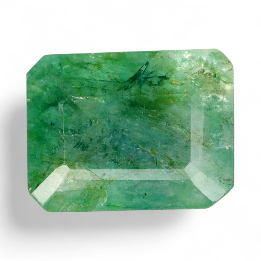12.18 Carats Vivid Green Beryl - Natural Loose Gemstone: This vibrant green beryl exhibits a lush, saturated color reminiscent of spring foliage, with a lively translucence that glows from within. Its faceted surface enhances the stone's natural brilliance,