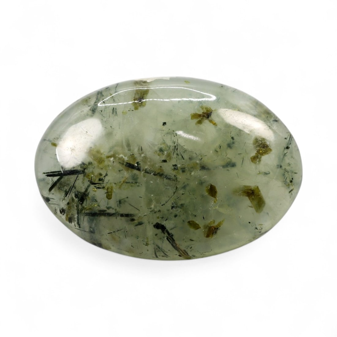 29.33 Carats Green Prehnite with Rutile Inclusions - Natural Loose Gemstone: This impressive prehnite cabochon displays a soft, misty green body, beautifully accented with fine black rutile inclusions suspended throughout the stone. The contrast between the serene green transl