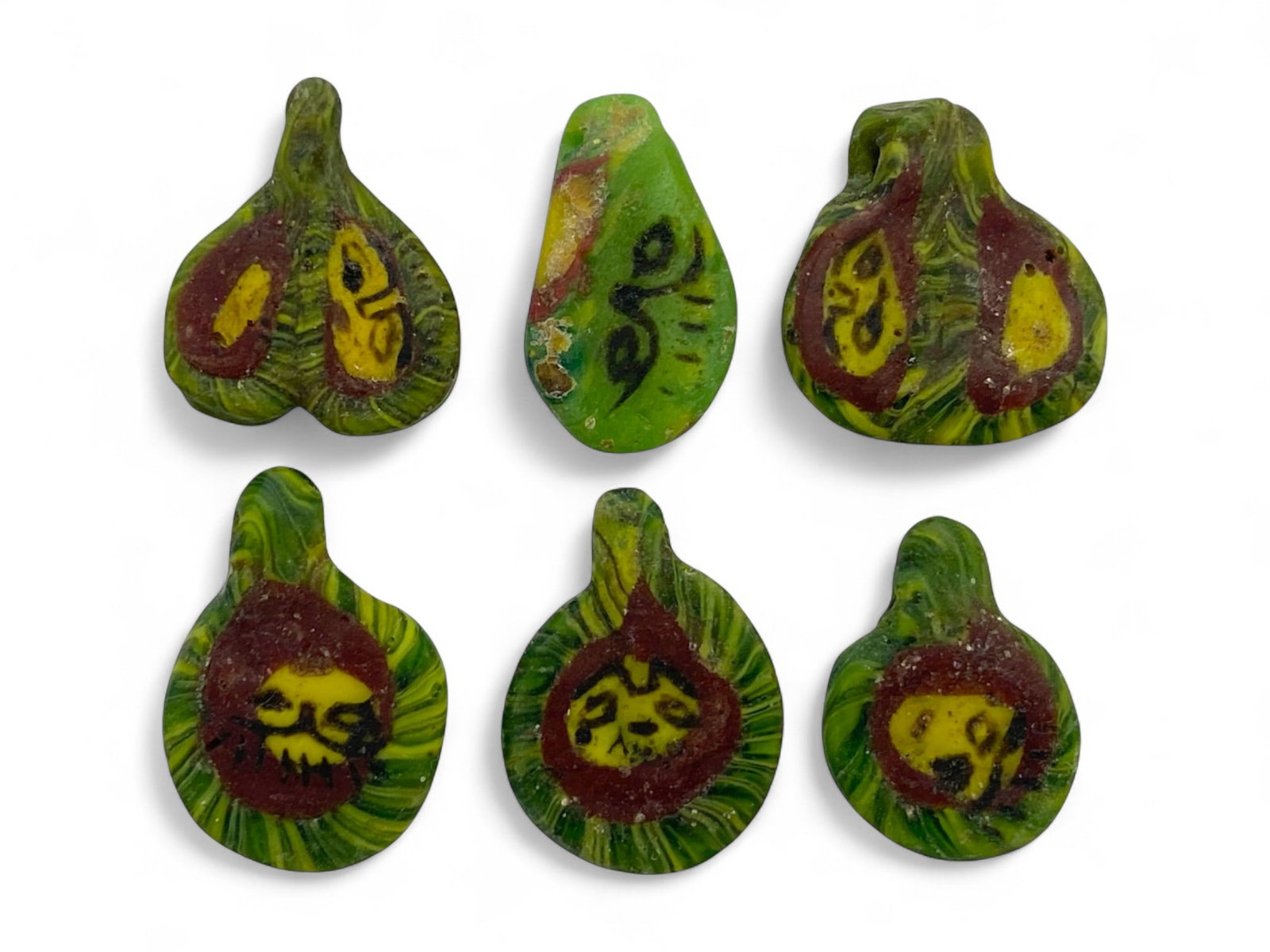 Ancient Egyptian Face Mosaic Glass Amulet Beads, c. 1st Millennium BCE, 10g: These rare ancient Egyptian mosaic glass beads, dating to the 1st millennium BCE, capture the artistic innovation and spiritual symbolism of one of history's most iconic civilizations. Shaped in a sty