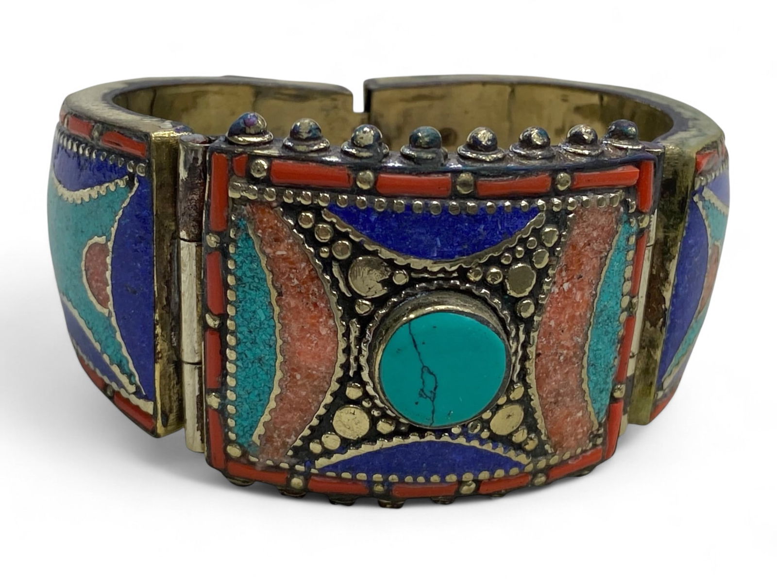 Tibetan Brass Ritual Bracelet with Turquoise-Coral-Lapis Inlay, c. 20th Century, 163g: This powerful ceremonial bracelet hails from the Himalayan region, likely Tibet or Nepal, and exemplifies the visual language of 20th-century ritual jewelry. Crafted from brass and richly adorned with