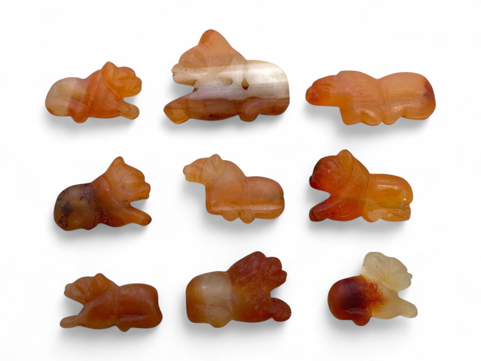 Ancient Medieval Coptic Egyptian Carnelian Reclining Feline Amulets, c. 6th-9th Century CE, 12g: This graceful set of nine miniature feline amulets, carved from richly banded carnelian, dates to the early Medieval Coptic period of Egypt, c. 6th-9th century CE. Ranging from 1 to 2 cm (0.4 to 0.8 i