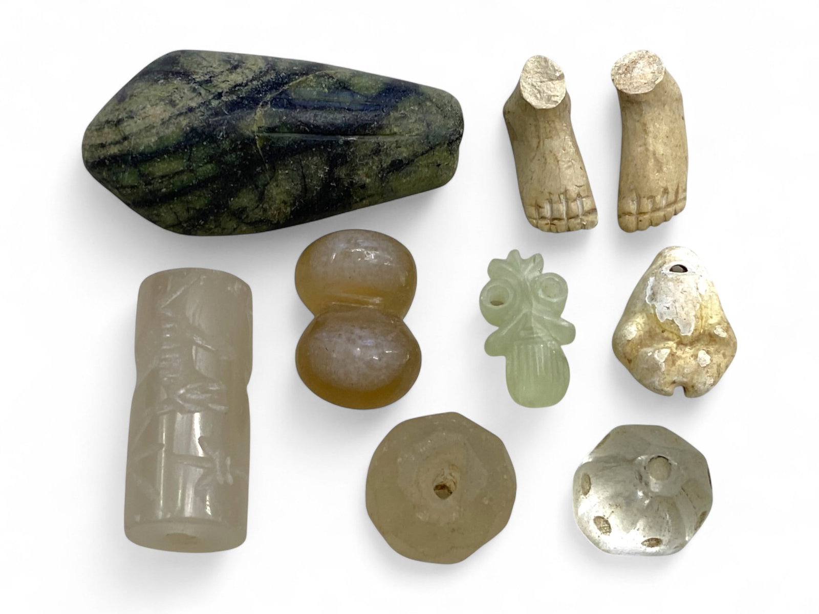 Ancient Mesopotamian and South Asian Ritual Relic Collection, c. 3rd-1st Millennium BCE, 44g: This rare and diverse group of nine miniature relics offers a vivid cross-section of ritual and decorative practices from ancient Mesopotamian, Elamite, and South Asian cultures. Dating from c. 3000 t