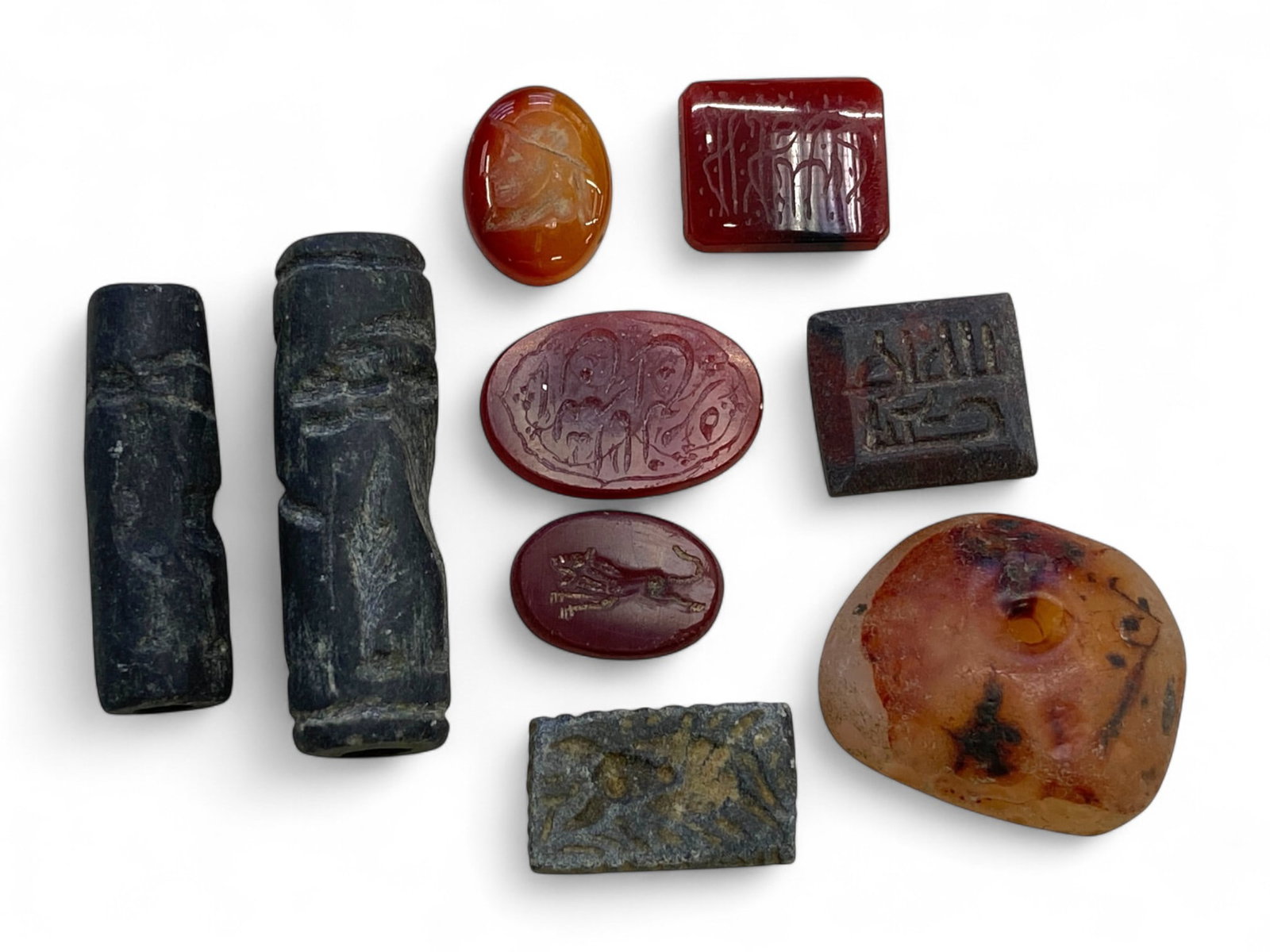 Set of 9 Intaglio and Cylinder Seals, Mesopotamian to Islamic, 41g: This curated ensemble of nine ancient seals captures the evolution of personal and administrative sealing practices from Bronze Age Mesopotamia to early Islamic caliphal courts. Ranging from approxima