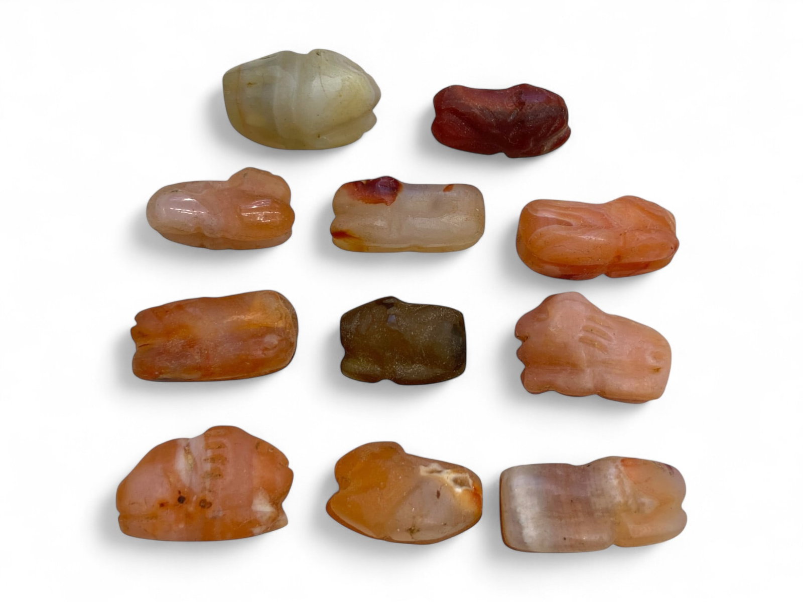 Ancient Coptic Egyptian Feline Amulet Collection, Carnelian Chalcedony, c. 4th-7th Century CE (34g): This evocative group of 11 hand-carved amulets represents a rare survival of early Coptic Egyptian spiritual art, dating to the 4th-7th century CE. Sculpted from richly colored carnelian, chalcedony, 