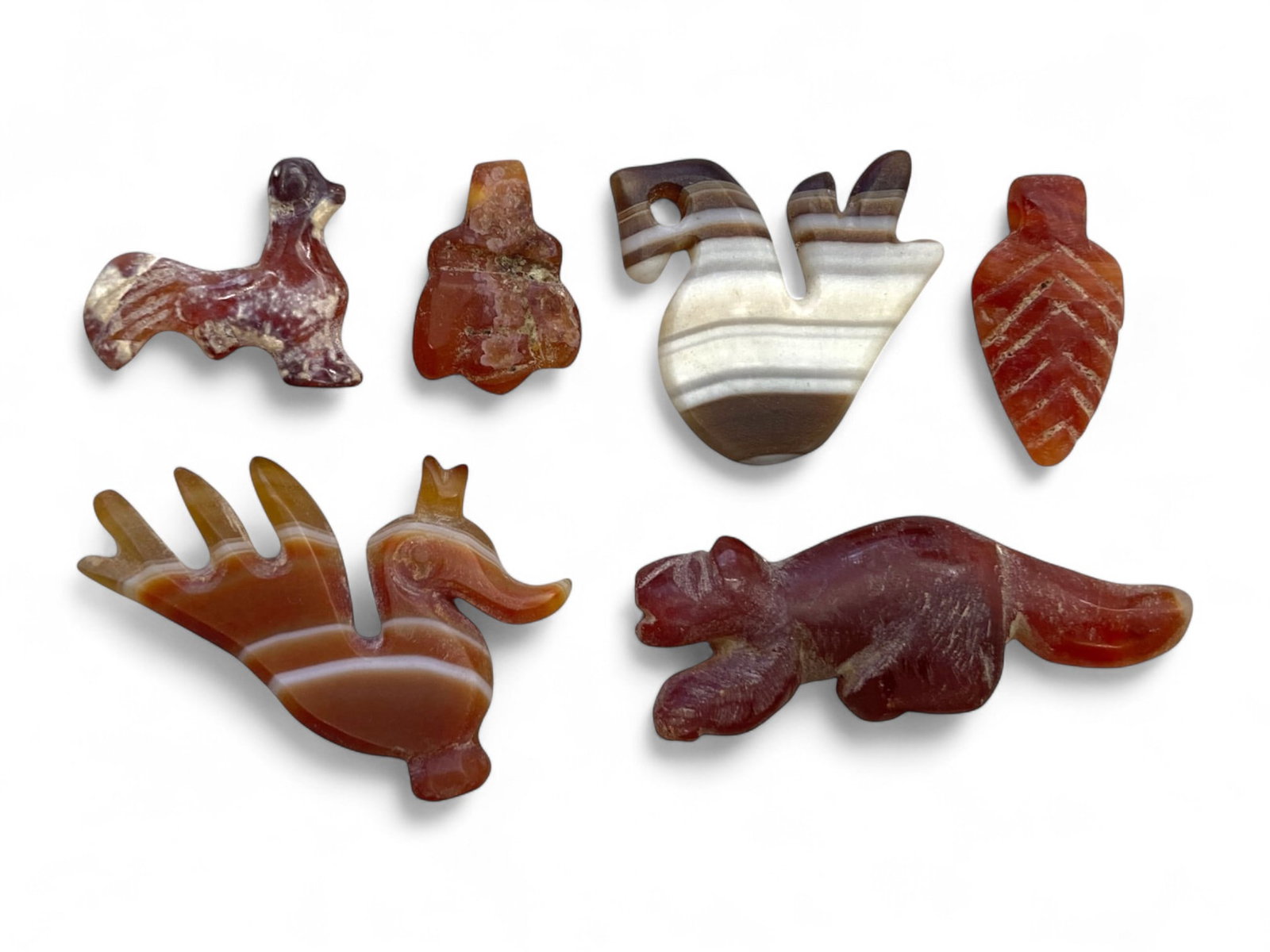 Ancient Medieval Eastern Animal & Symbolic Agate Amulet Set, c. 10th-14th Century CE (14g): This delightful collection of six miniature amulets, hand-carved from richly banded agate and deep carnelian, reflects the enduring folk traditions of Medieval Eastern Europe or the Islamic-influenced