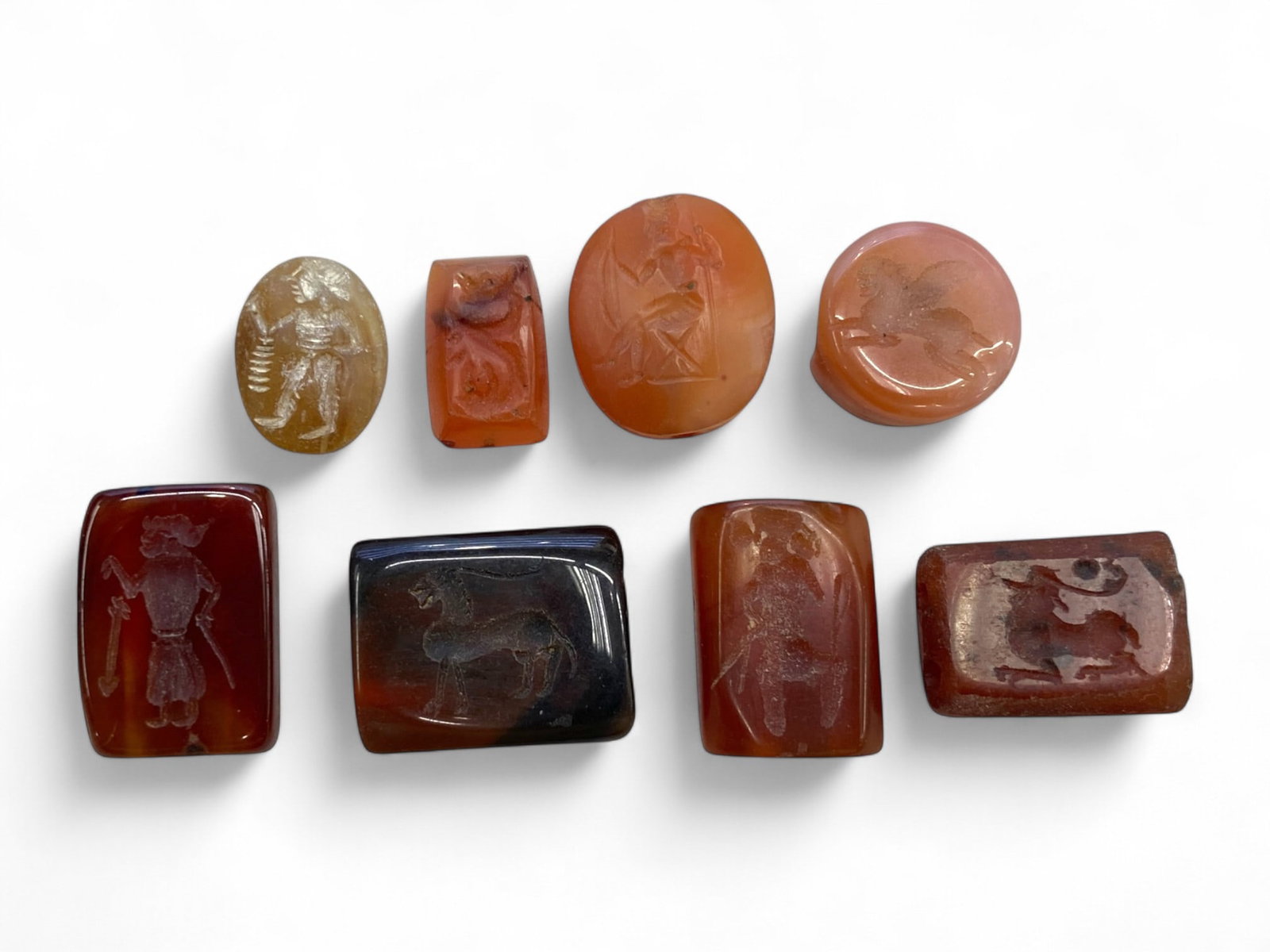 Ancient Greco-Parthian Carnelian Intaglio Seal Collection, c. 1st BCE-3rd CE (24g): This fine collection of eight engraved carnelian and agate intaglios represents the height of ancient miniature lapidary art from the Greco-Parthian and early Sasanian periods, c. 1st century BCE to 3