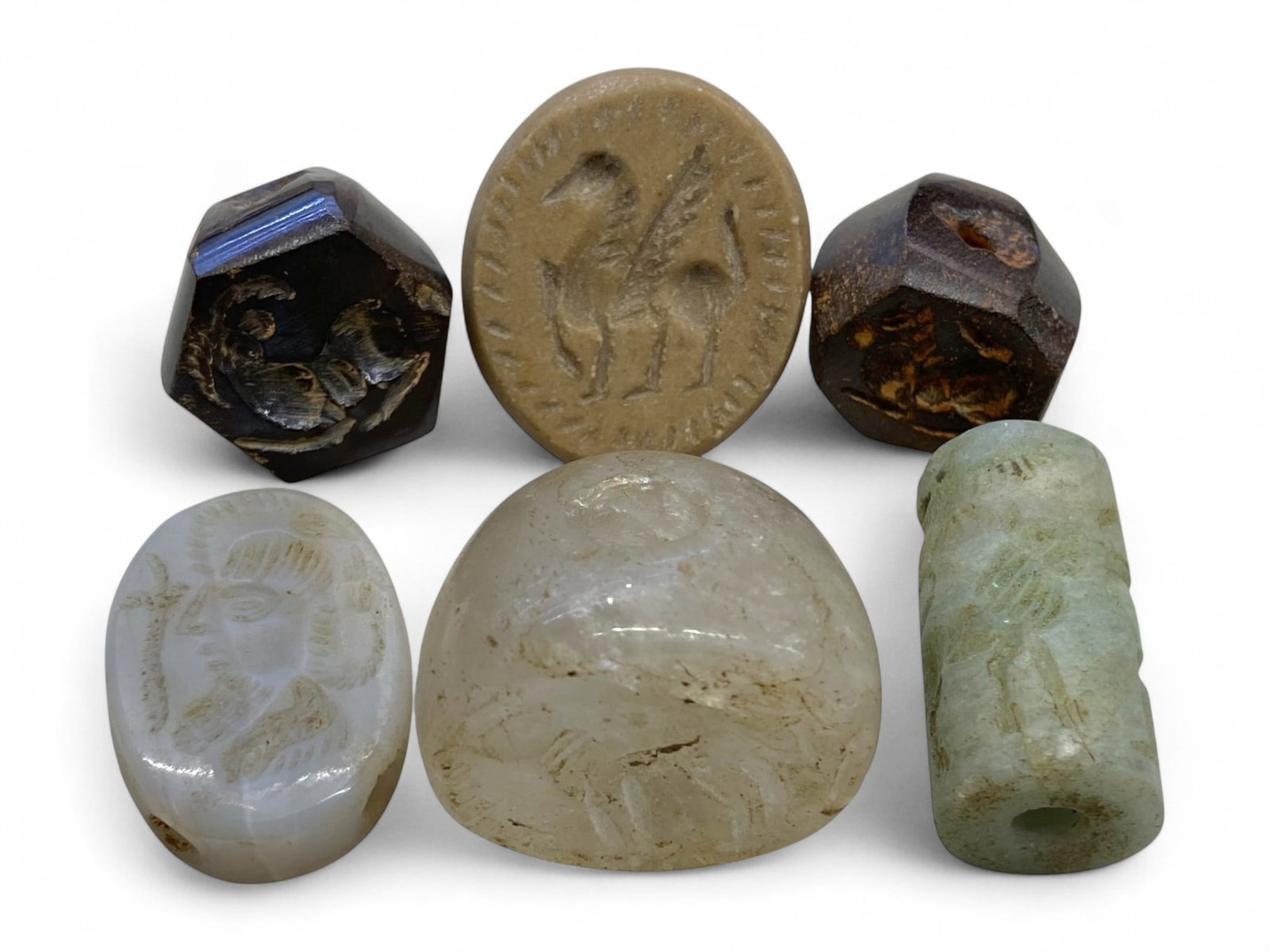 Ancient Near Eastern Stamp and Cylinder Seal Collection, c. 1000 BCE-300 CE, 88g: This remarkable group of six engraved seals embodies the rich visual and symbolic language of the Ancient Near East. Ranging from c. 1000 BCE to 300 CE, the collection includes both stamp and cylinder