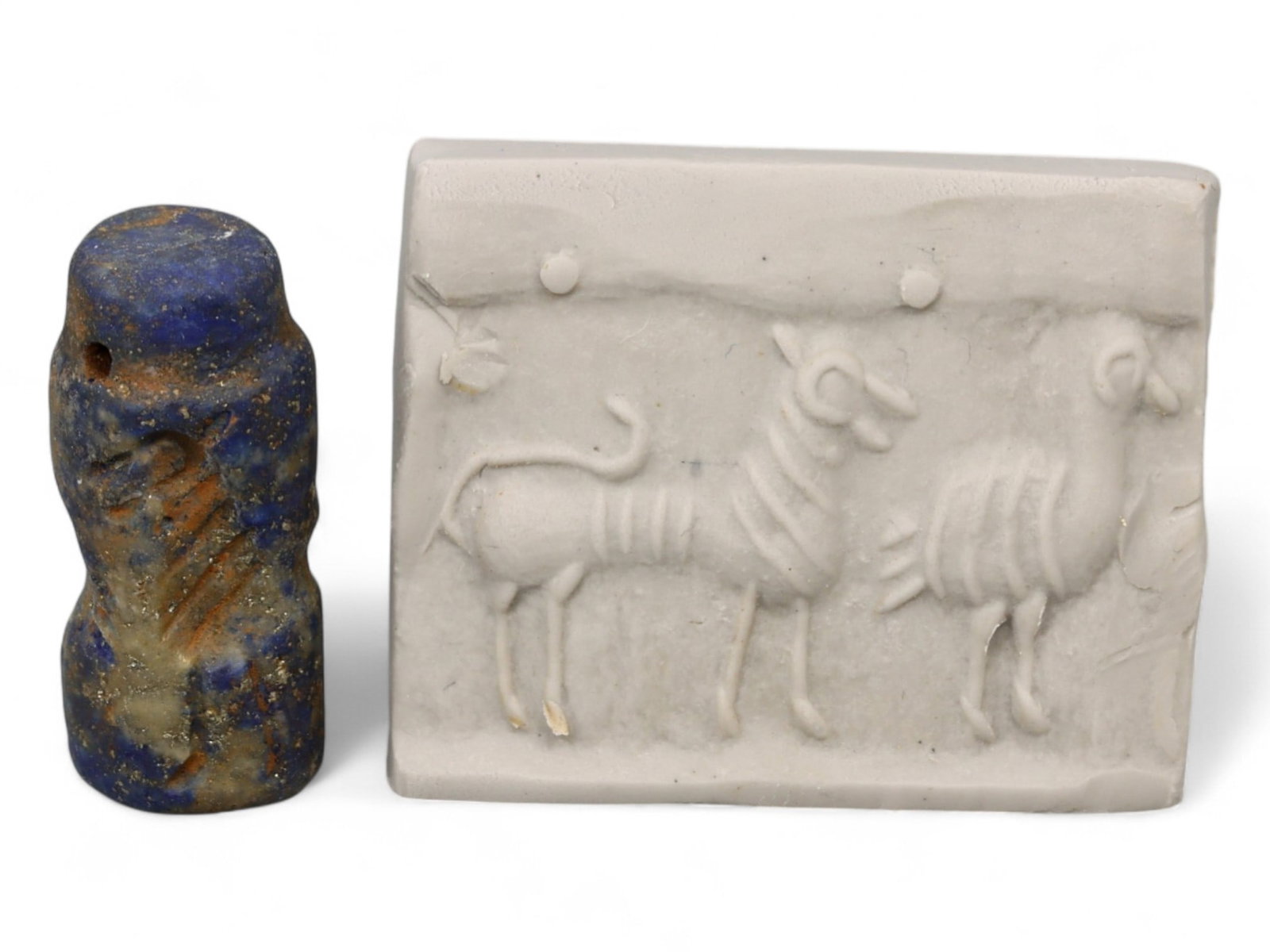 Ancient Akkadian Striped Goat Motif Lapis Lazuli Cylinder Seal, c. 2350-2150 BCE, 5.4g: This striking lapis lazuli cylinder seal, dating to the Akkadian Period (c. 2350-2150 BCE), showcases the refined artistry and symbolic depth of Mesopotamian craftsmanship. Measuring approximately 0.9