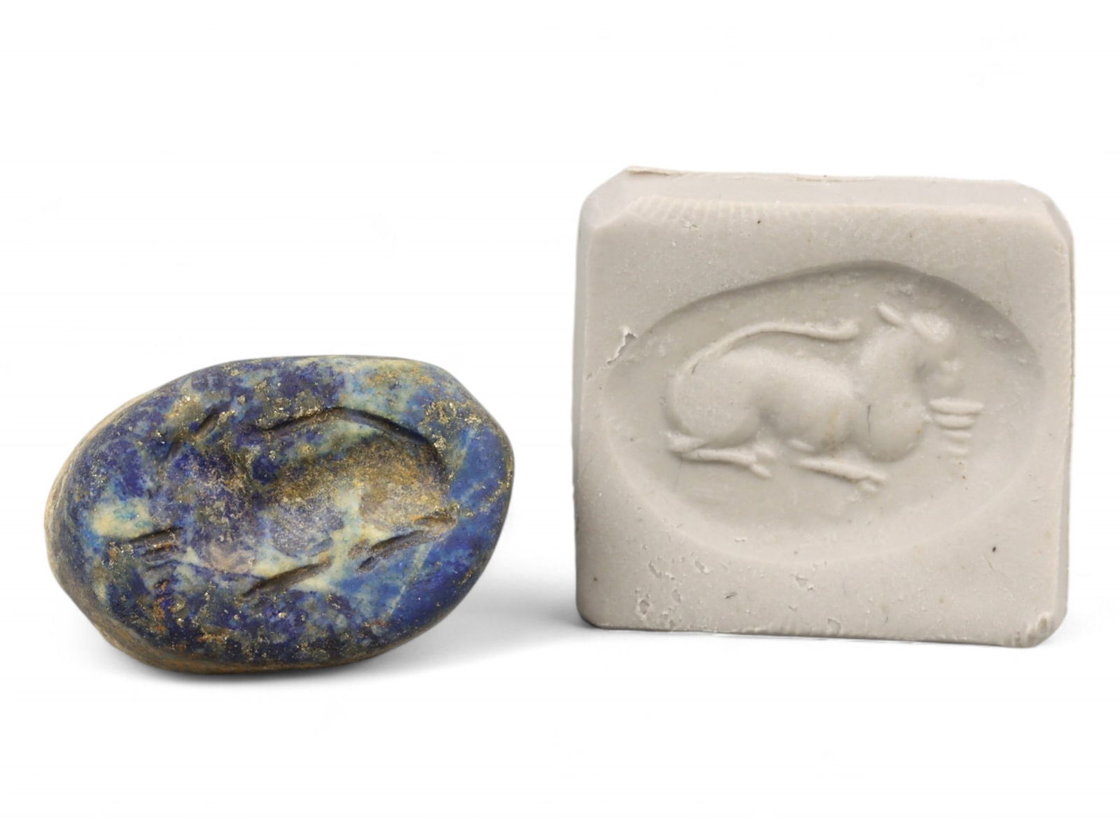 Ancient Akkadian Reclining Bull Lapis Lazuli Stamp Seal, c. 2350-2150 BCE, 10g: This elegant Akkadian stamp seal, carved from richly veined lapis lazuli and weighing 10 grams (0.35 oz), features the timeless image of a reclining bull, a motif deeply embedded in the Mesopotamian s