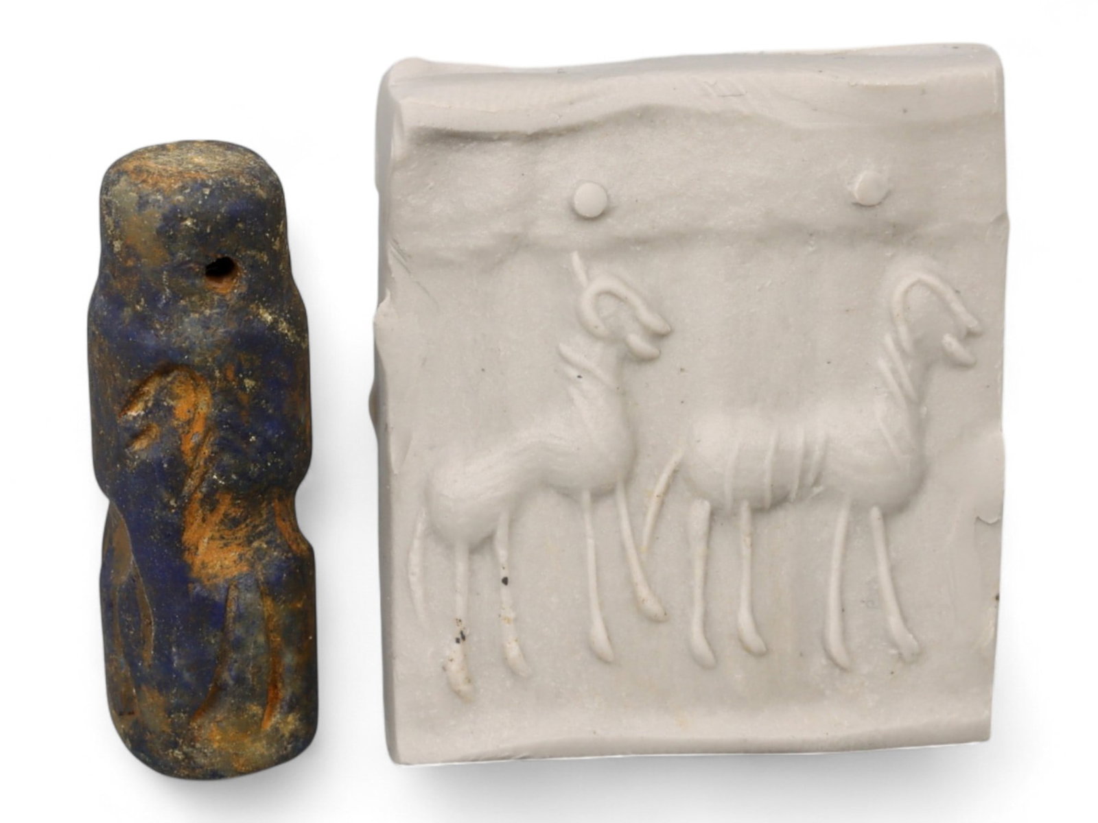 Ancient Akkadian Twin Ram and Disc High-Relief Lapis Lazuli Cylinder Seal, c. 2350-2150 BCE, 4.6g: This finely carved Akkadian cylinder seal, measuring 2.7 x 1 cm and weighing 4.6 grams, is crafted from rare lapis lazuli, a gemstone treasured in the ancient Near East for its deep blue hue and exoti