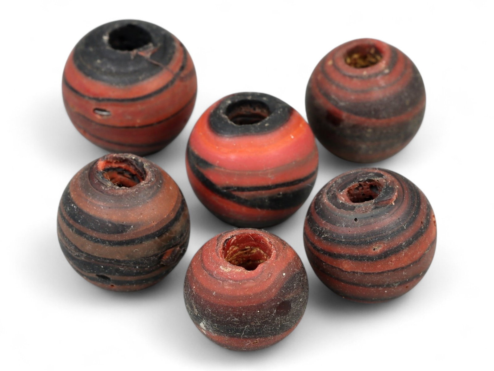 Lot of 6 Medieval Persian Swirl Glass Beads, 13th-14th Century, 1.3-1.5cm, 23g: Vibrant and rhythmically striated, this matched group of six spherical beads exemplifies Persian glasswork from the Islamic Golden Age, likely produced in the 13th-14th century CE. Ranging in diameter