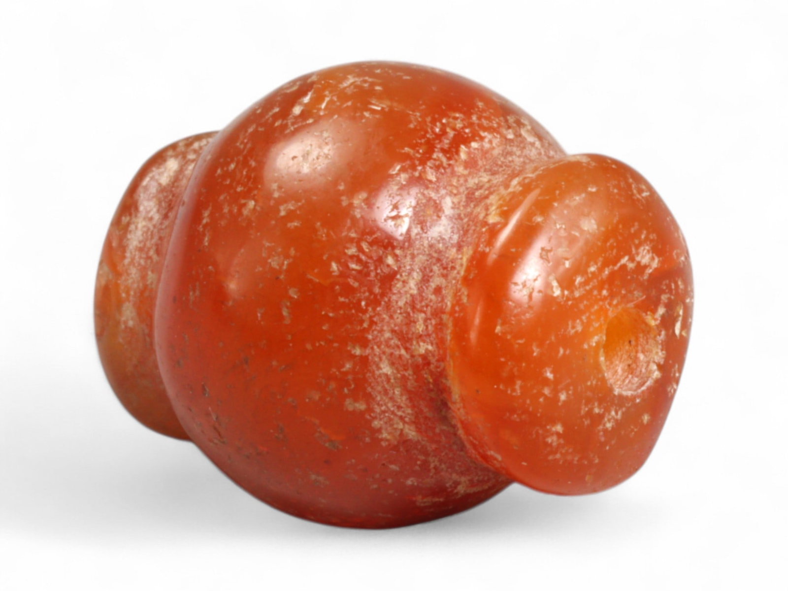 Ancient Medieval Chola Collared Carnelian Trade Bead, c. 9th-13th Century CE, 1.9cm, 4g: This finely polished carnelian bead, carved in a classic collared form, originates from the powerful Chola Dynasty of South India, a civilization that thrived between the 9th and 13th centuries CE. Th