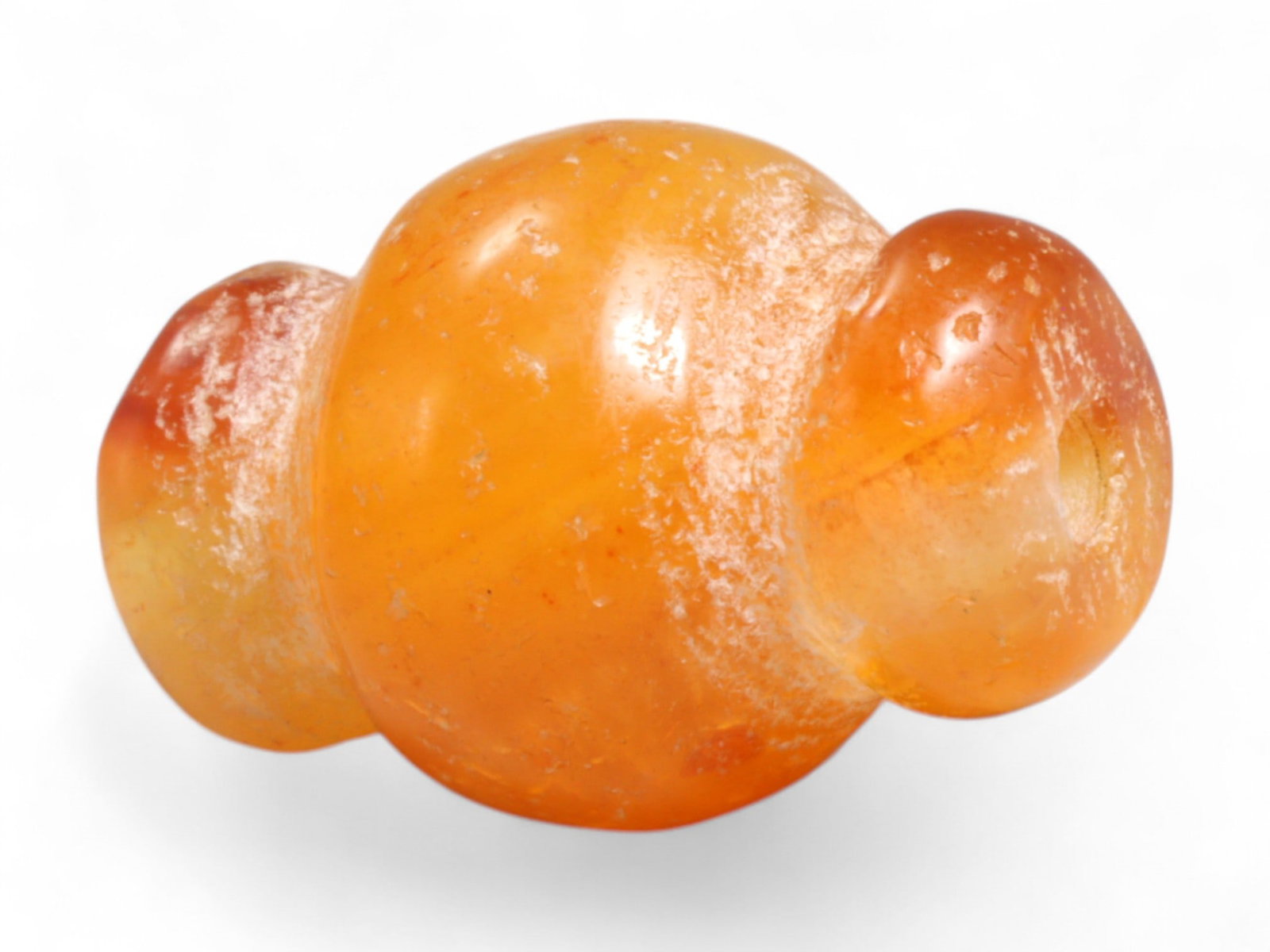 Ancient Medieval Chola Collared Carnelian Trade Bead, c. 9th-13th Century CE, 1.9cm, 4g: This finely polished carnelian bead, carved in a classic collared form, originates from the powerful Chola Dynasty of South India, a civilization that thrived between the 9th and 13th centuries CE. Th